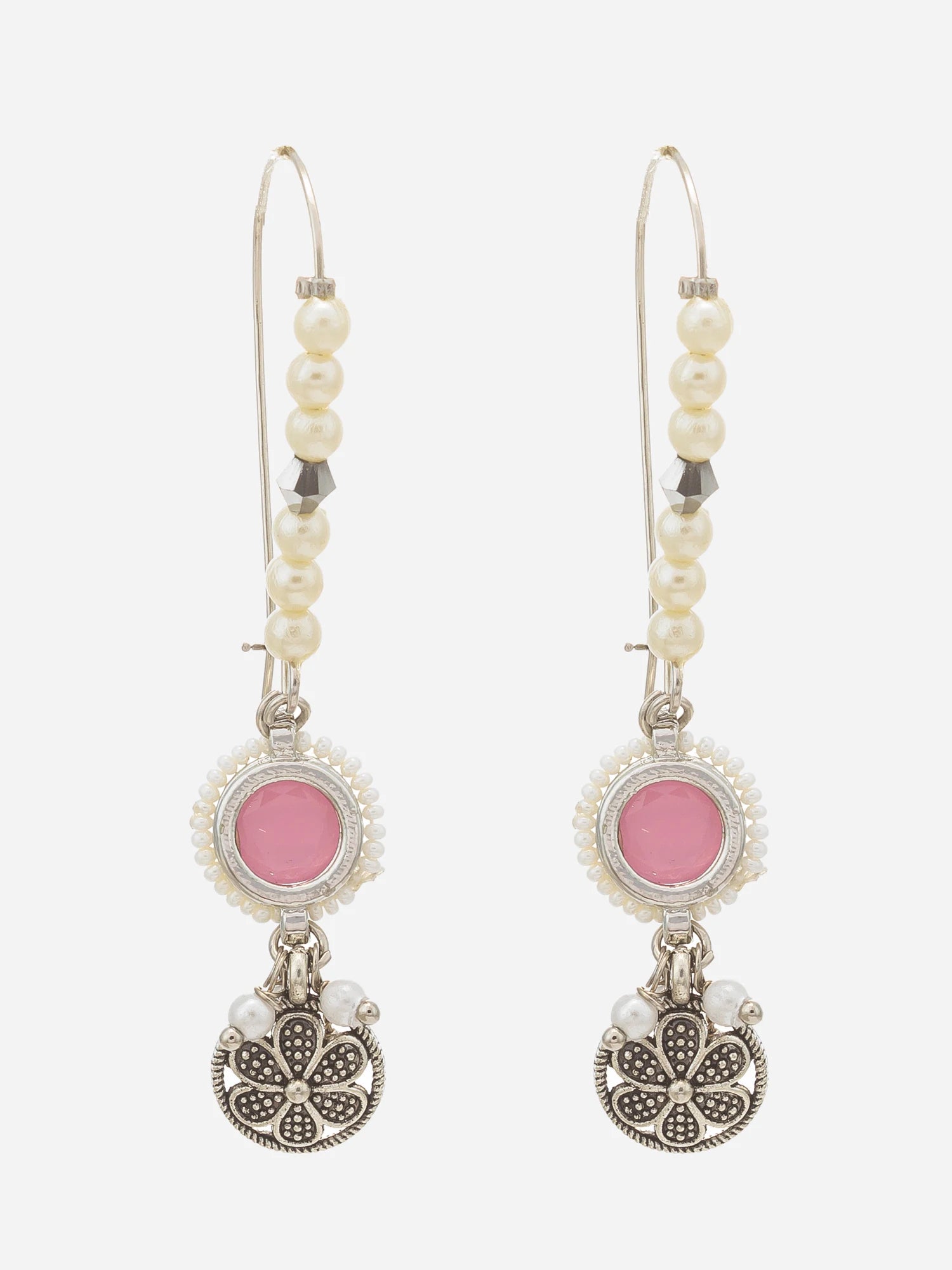 A pair of bohemian-style dangle earrings featuring white faux pearls, silver filigree, and pink circular accents, shown against a light gray background.