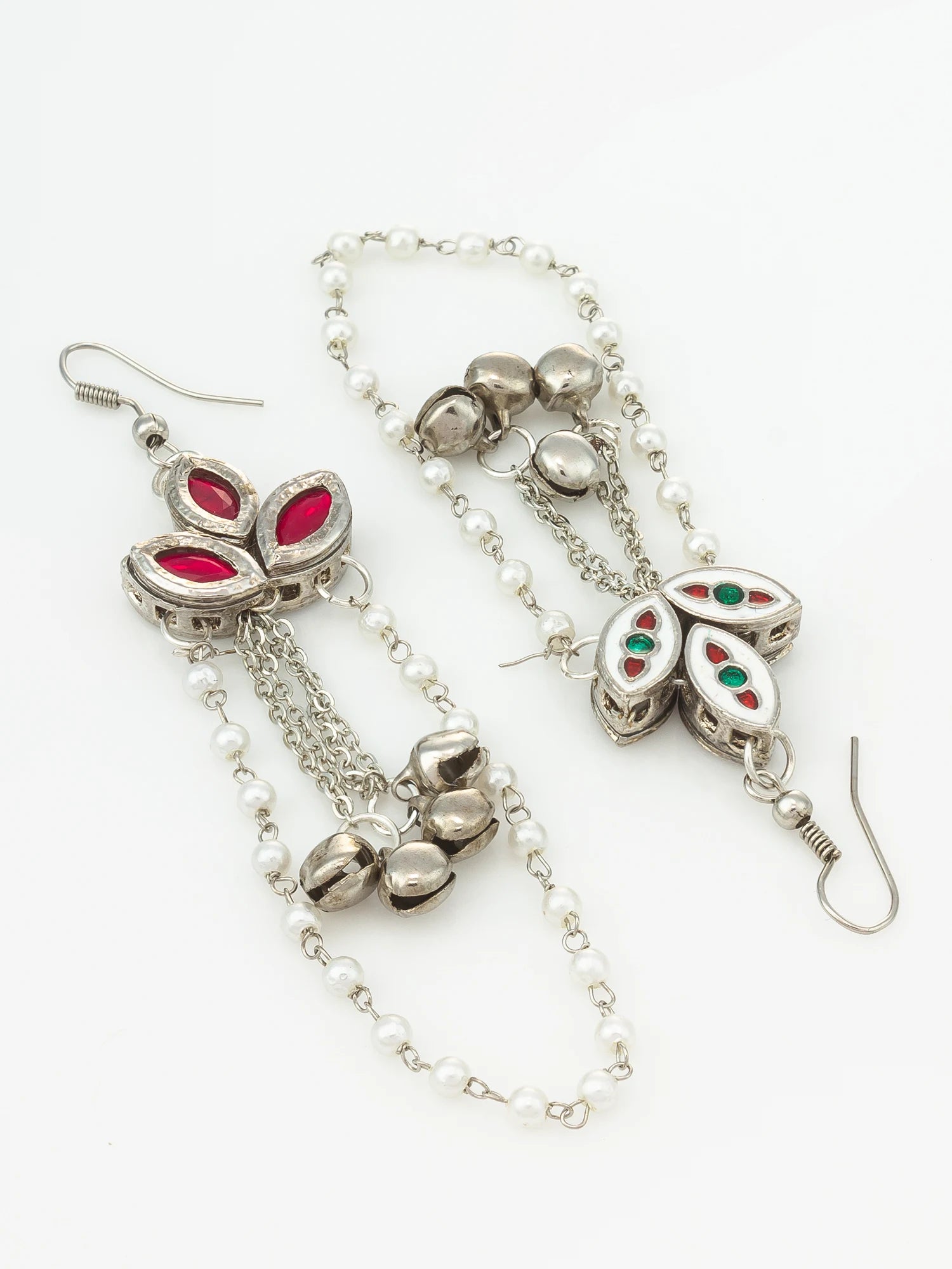 Silver-toned dangle earrings with white pearl-like beads, floral silver motifs, and red and green stone accents, shown on a plain white background.