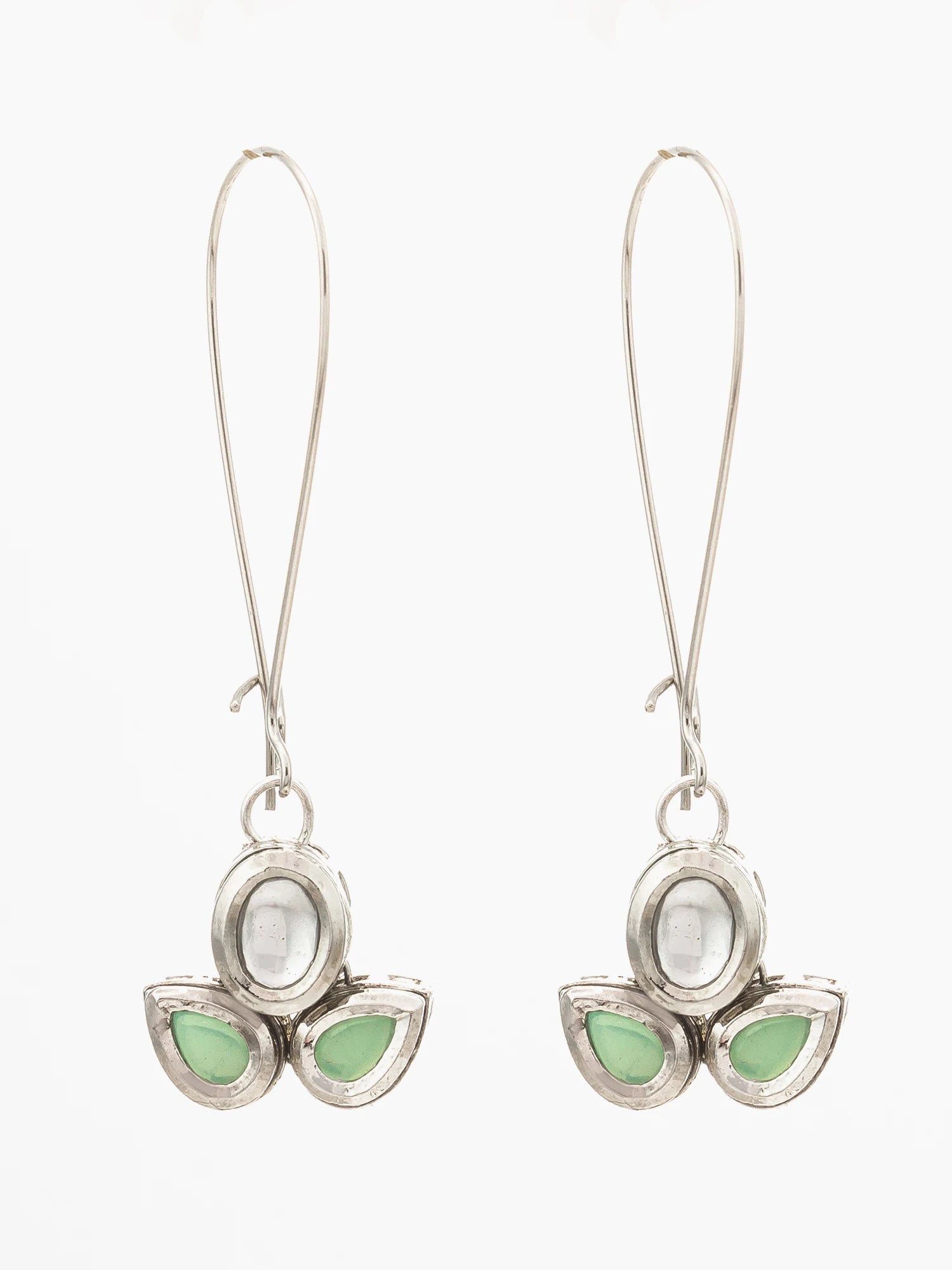 A pair of silver-toned dangle earrings with a lotus flower design, featuring a central oval white stone and three teardrop-shaped light green stones at the bottom, set against a plain white background.