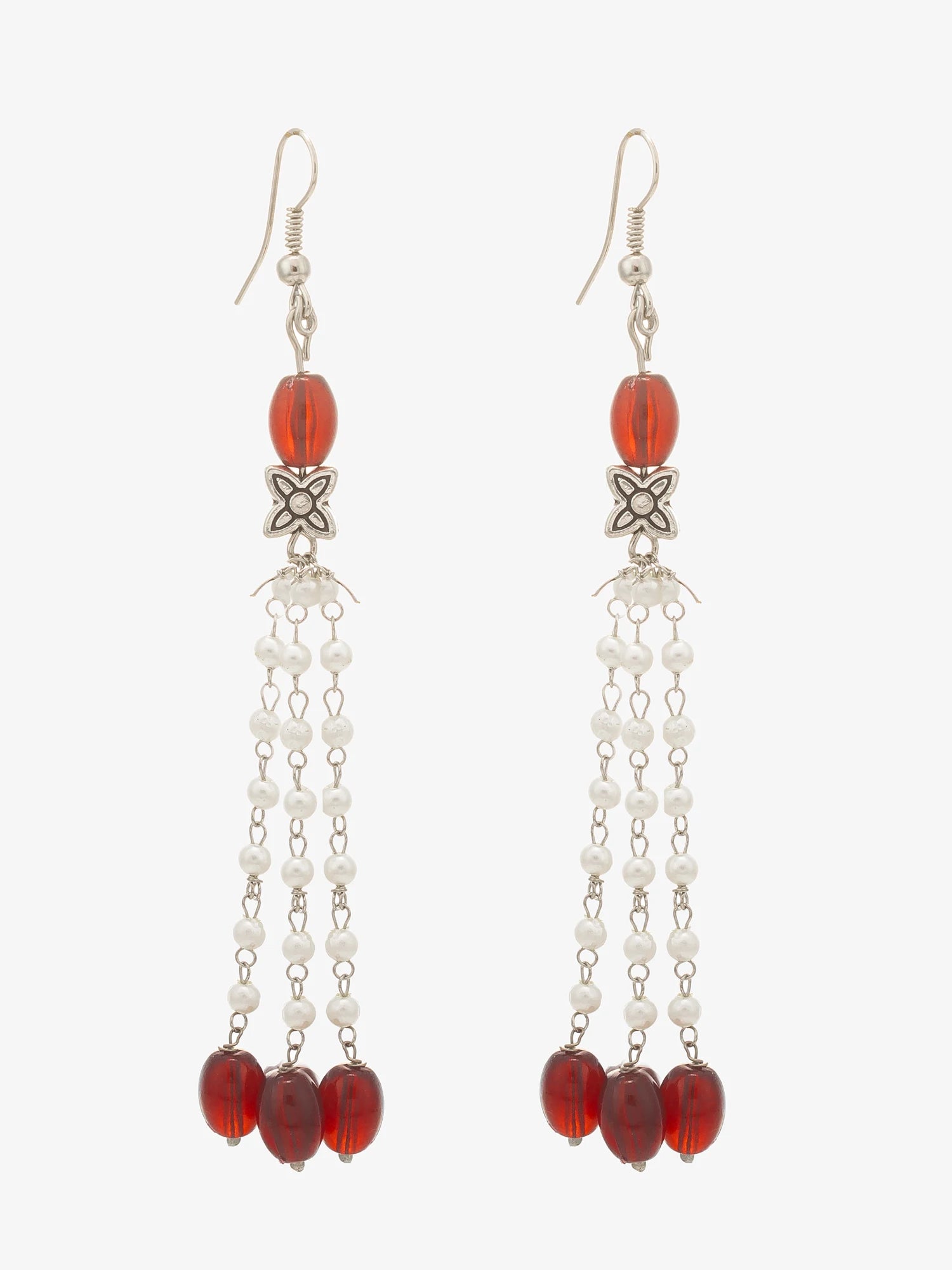 A pair of long dangle earrings with silver-toned hooks, red faceted beads, white pearl-like beads, and a small silver decorative element, shown on a plain light background.
