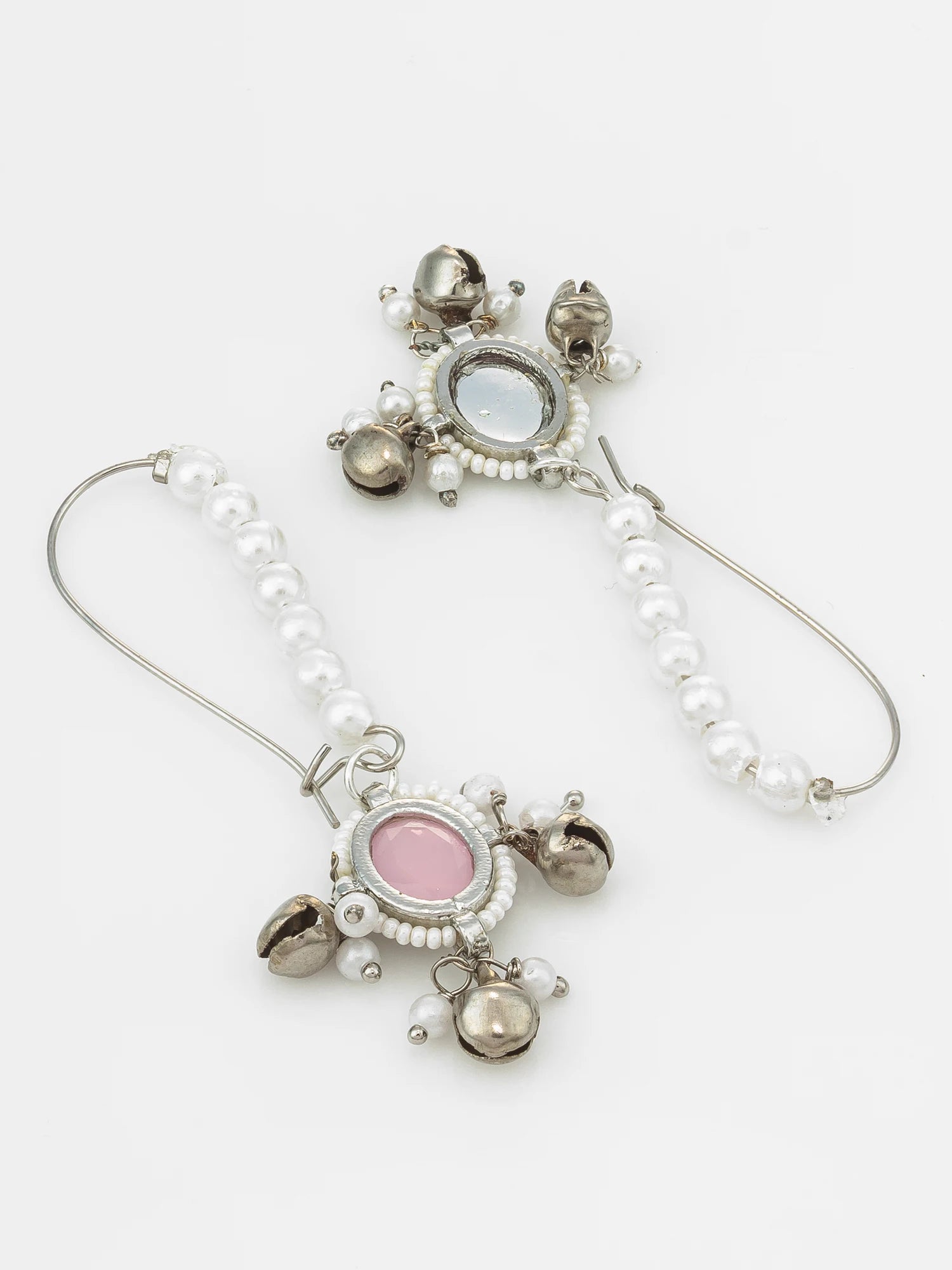 A pair of bohemian-style dangle earrings featuring white faux pearls, silver-toned metal, small bell charms, and oval pink and light blue stones, displayed on a clean white background.