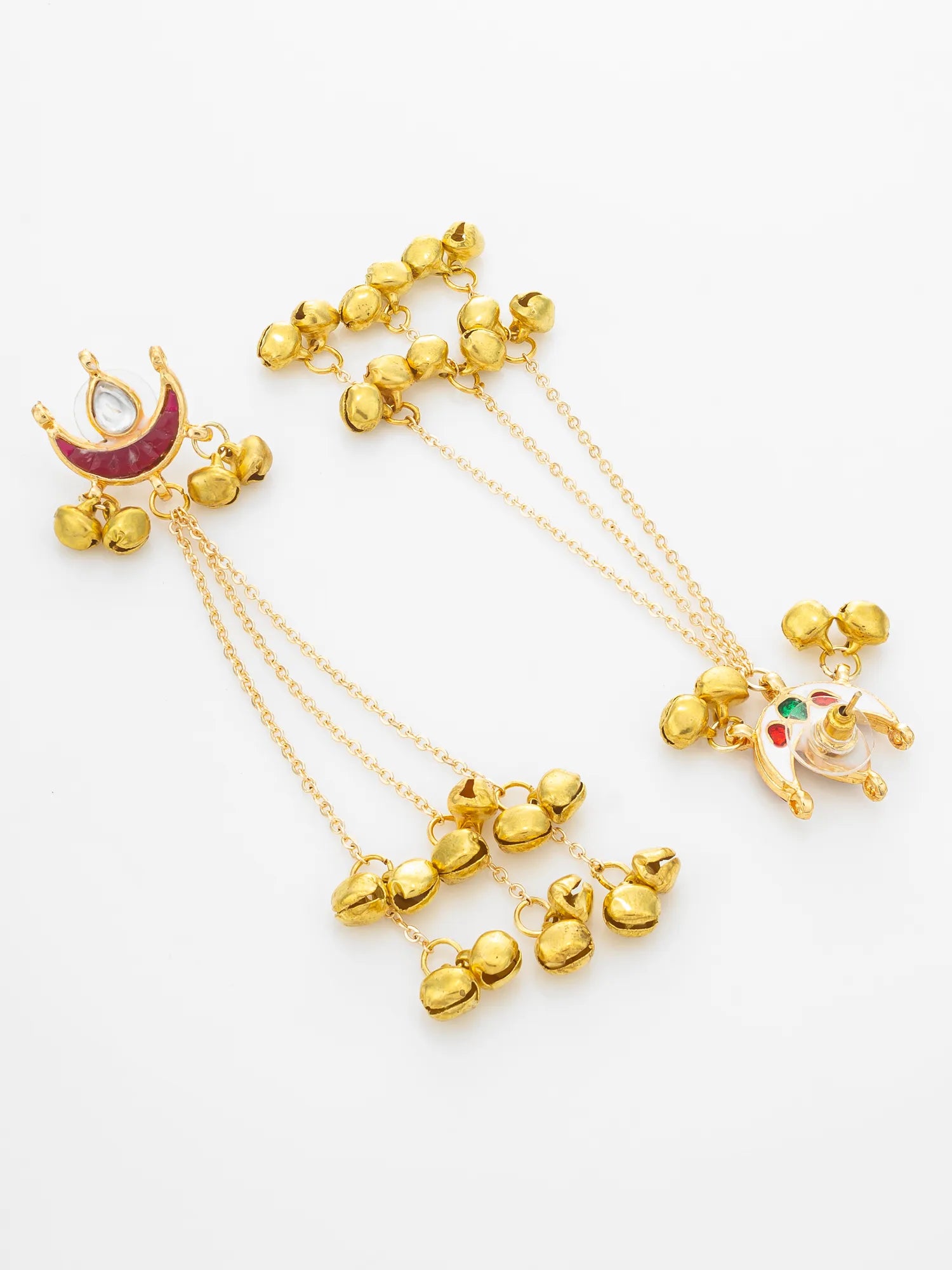 Gold-toned traditional Indian earrings with dangling chains, small bell charms, a crescent moon with red enamel, and a small animal charm with green and red accents, displayed on a white background.