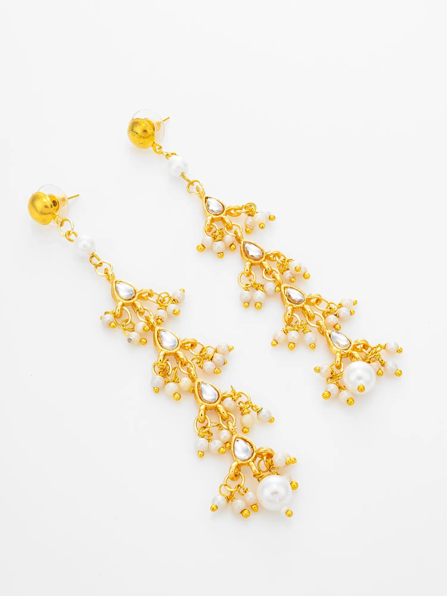 A pair of gold-tone dangle earrings with white pearl-like beads and clear teardrop rhinestones, displayed on a clean white background.