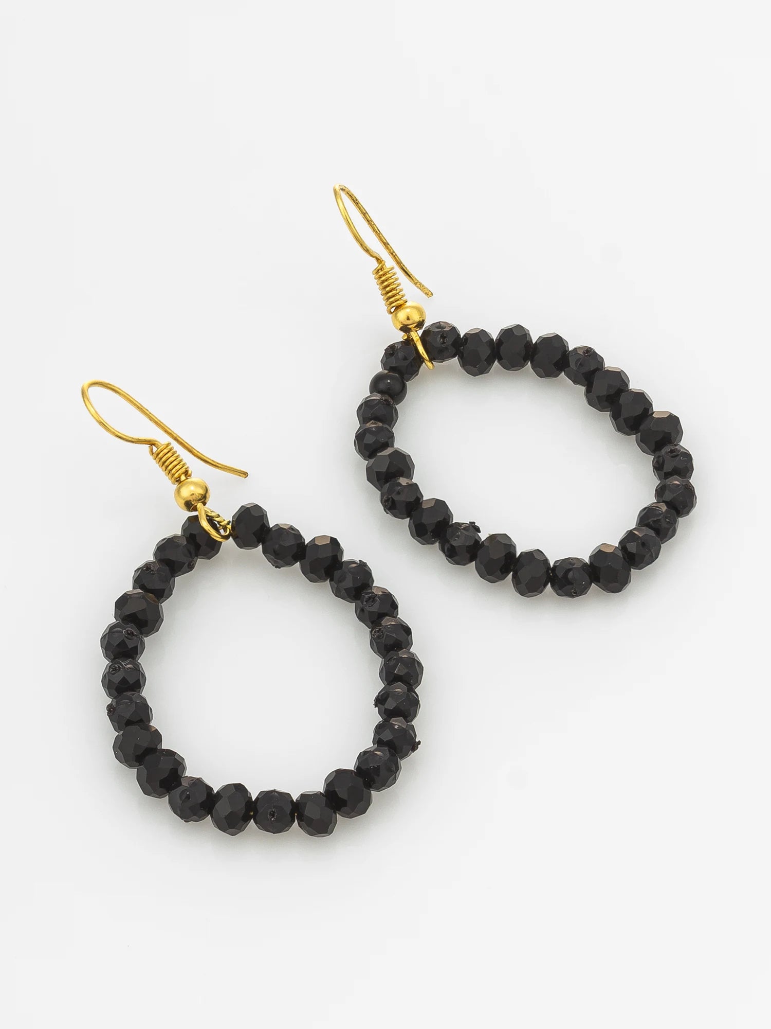 Black faceted bead hoop earrings with gold fishhook ear wires, displayed on a clean white background.