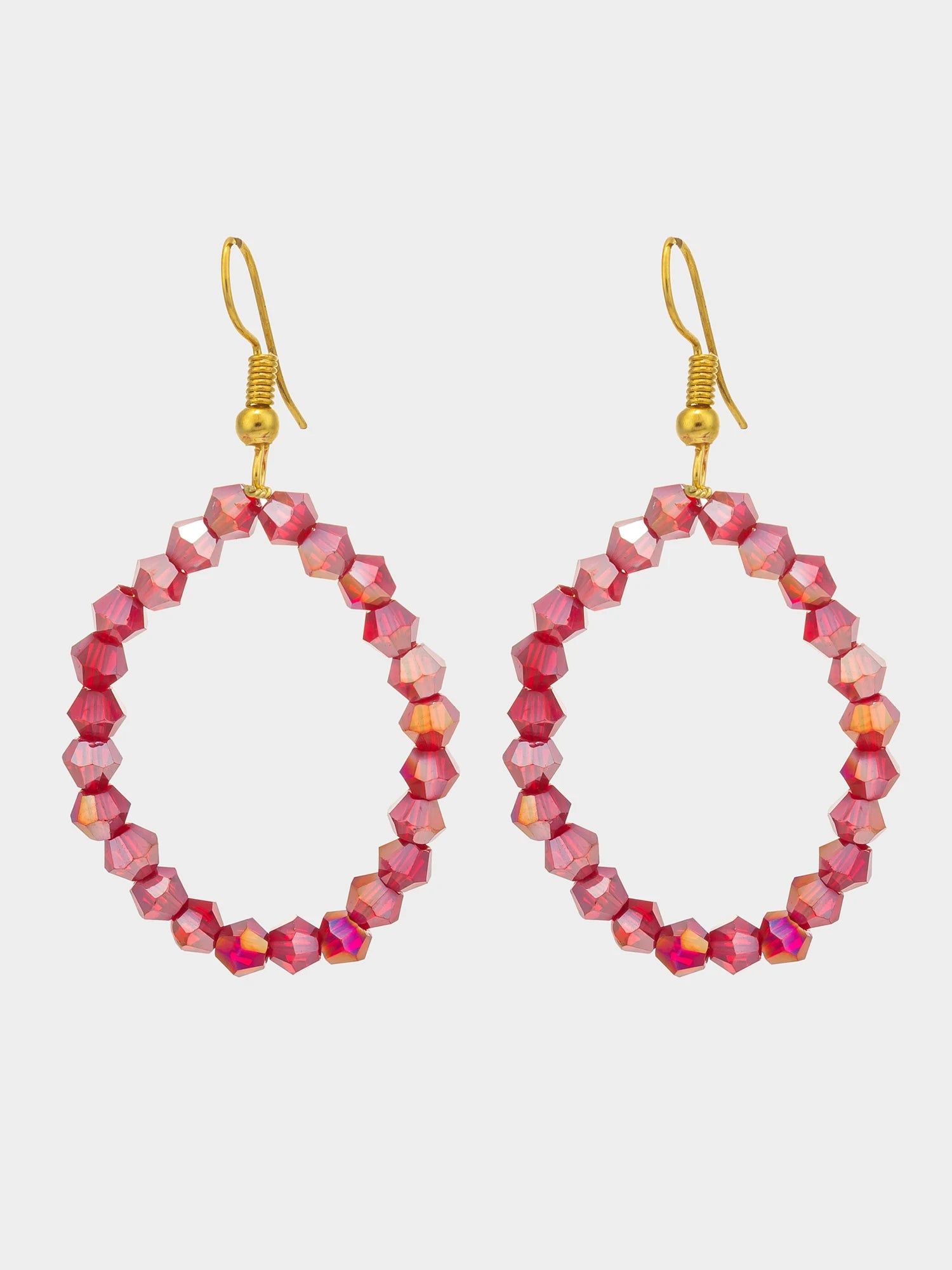 A pair of large oval hoop earrings made of faceted pink beads with gold fishhook ear wires, shown against a light gray background.