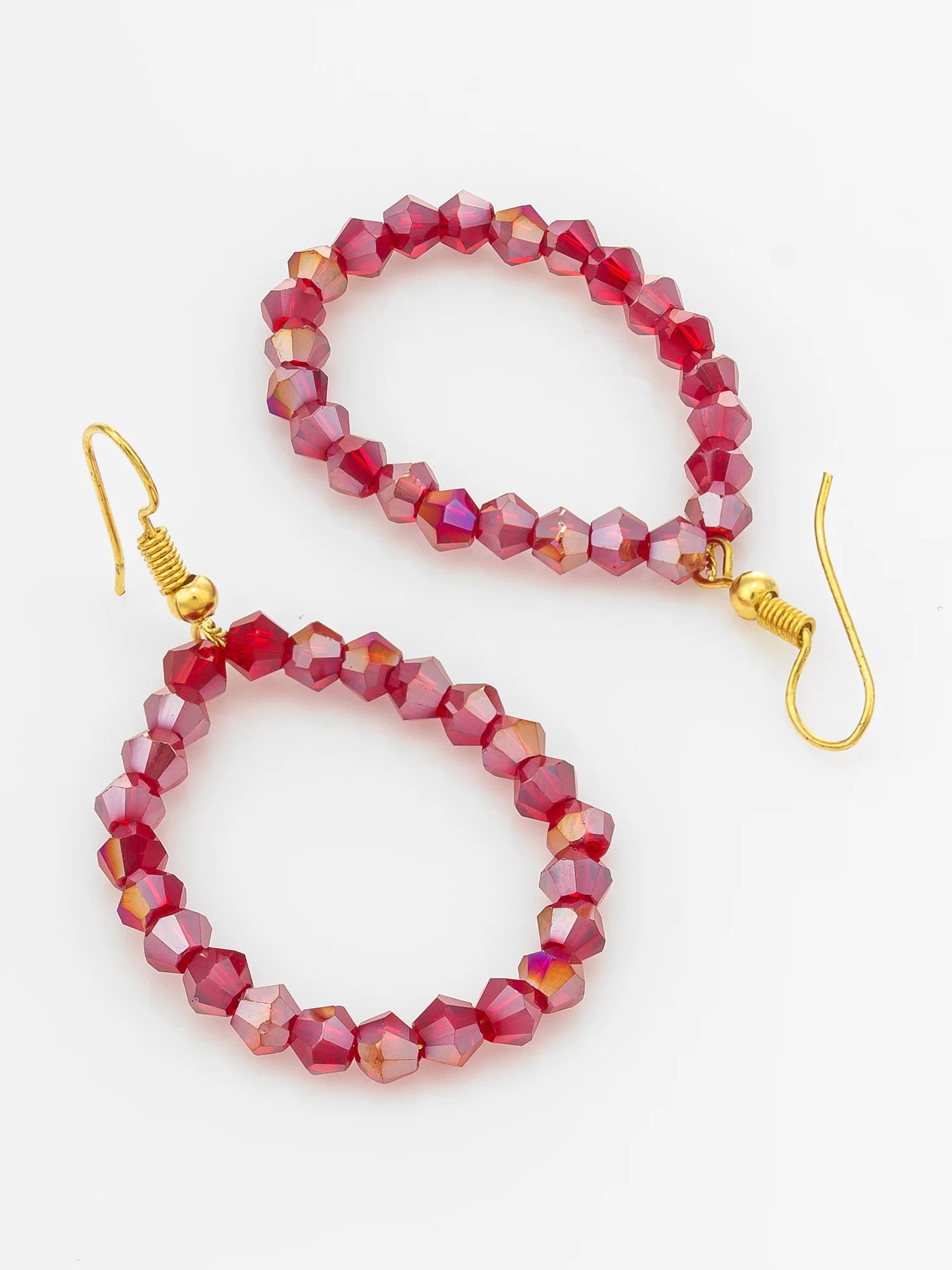 A pair of beaded drop earrings with faceted red beads and gold fishhook ear wires, displayed on a clean white background.