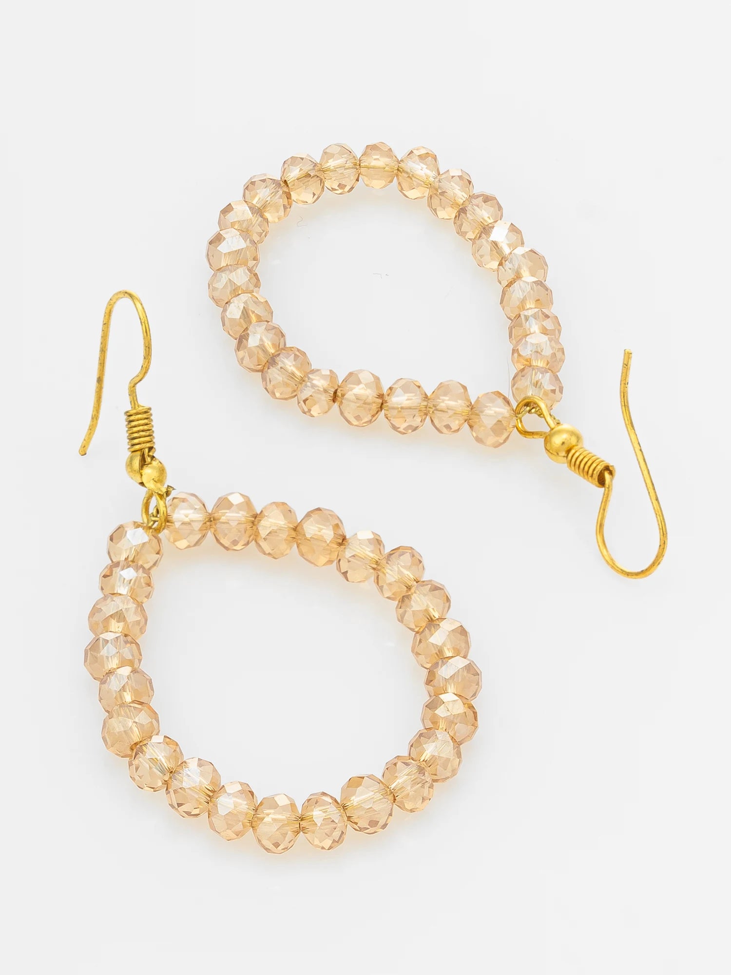 A pair of gold-tone drop earrings with beaded loops made of faceted, transparent champagne-colored beads, shown on a plain white background.