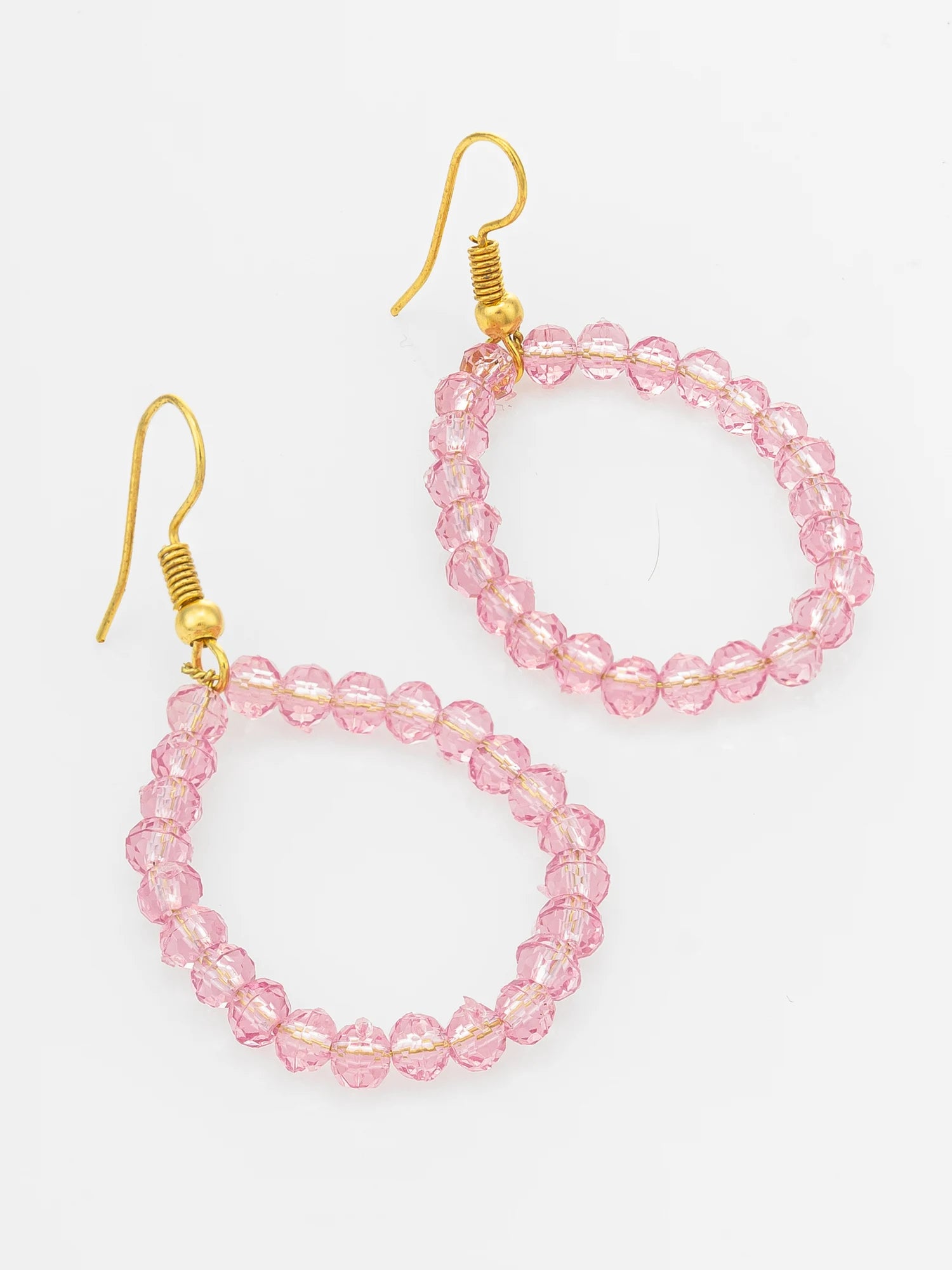 A pair of dangling hoop earrings made of faceted light pink beads connected by thin gold-tone wires, hanging from gold fishhook ear wires on a plain white background.