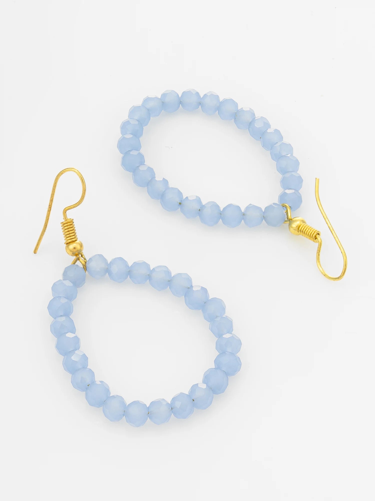 Light blue faceted bead drop earrings with gold fishhook wires, displayed on a clean white background.