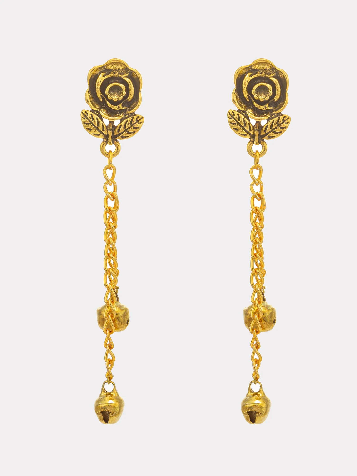 A pair of gold-toned dangle earrings featuring a rose-shaped stud with leaf details, connected by a short chain to a longer chain with three small bell charms, shown against a light gray background.