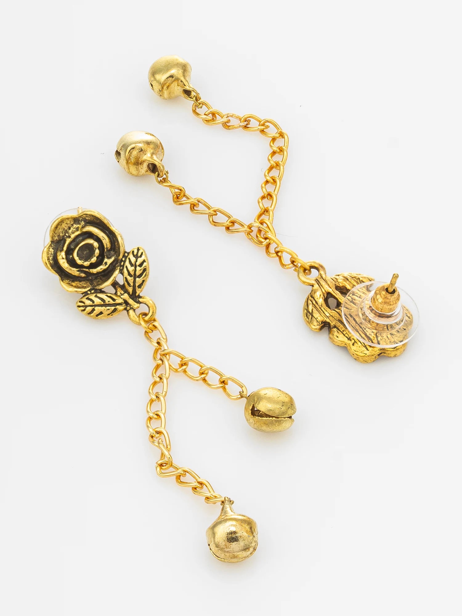 A pair of gold-toned dangle earrings featuring a rose motif, small leaf accents, chain links, and bell-shaped charms on a plain white background.