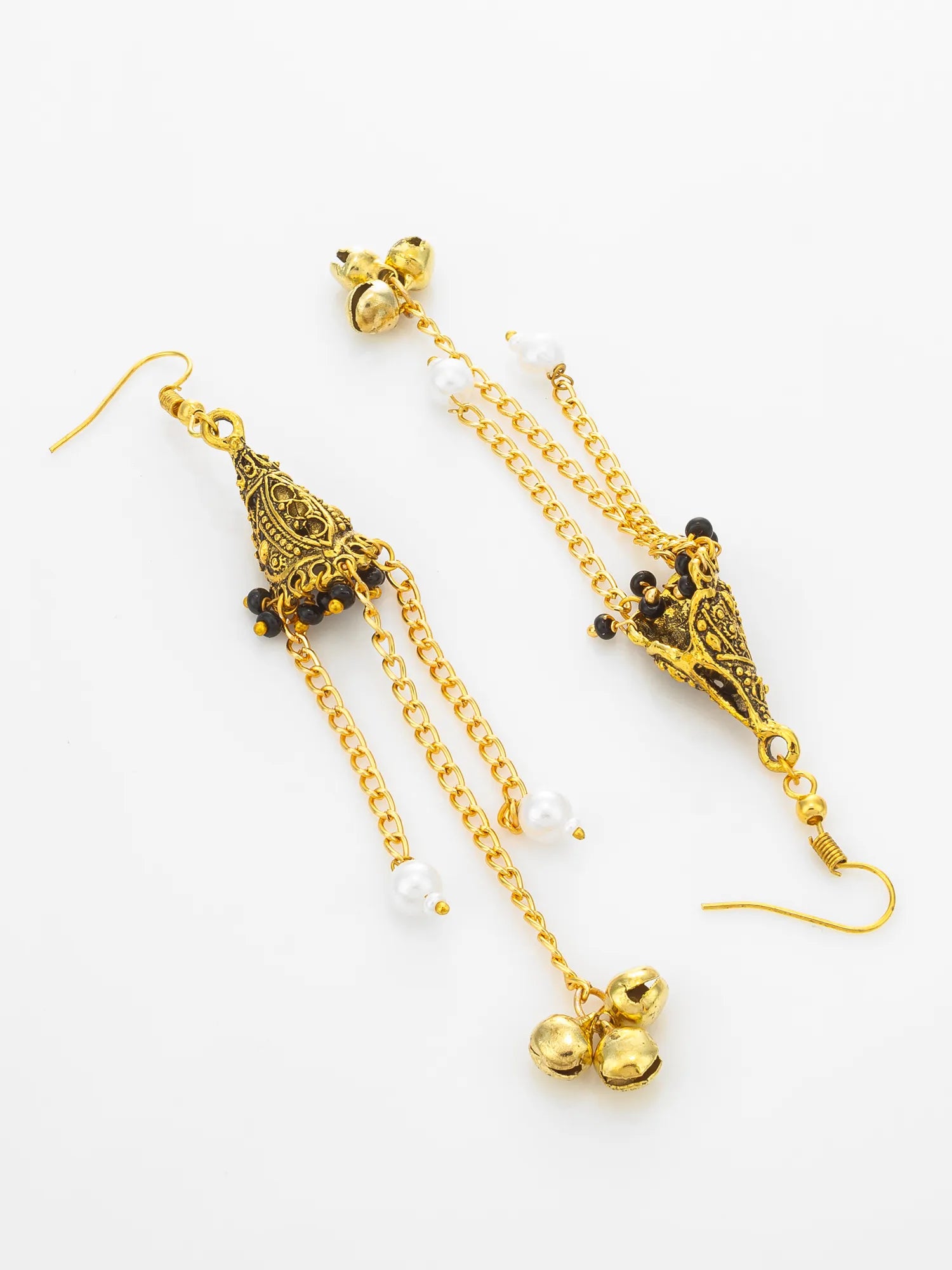 A pair of gold-toned traditional Indian jhumka earrings with ornate filigree details, small black bead accents, white pearl-like beads, and dangling bell charms, displayed on a clean white background.