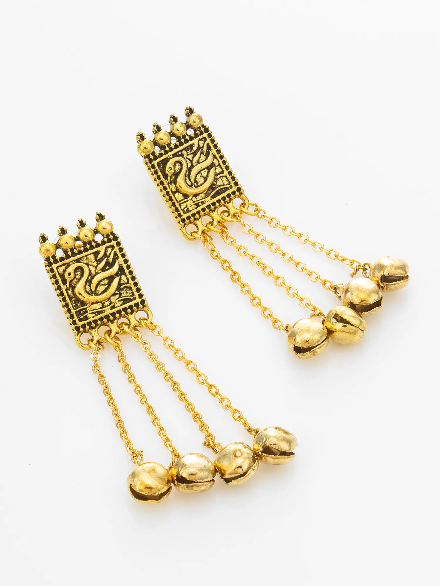 A pair of gold-toned dangle earrings with rectangular engraved panels, hanging chains, and three small bell charms, shown on a plain light background.