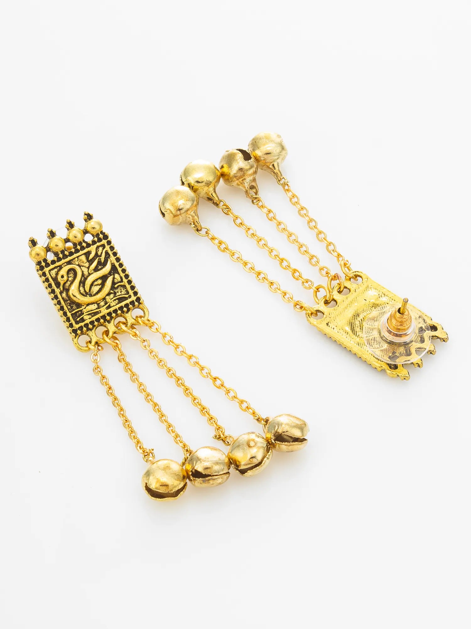 A pair of gold-toned dangle earrings with rectangular engraved panels, hanging chains, and three small bell charms, shown on a plain light background.