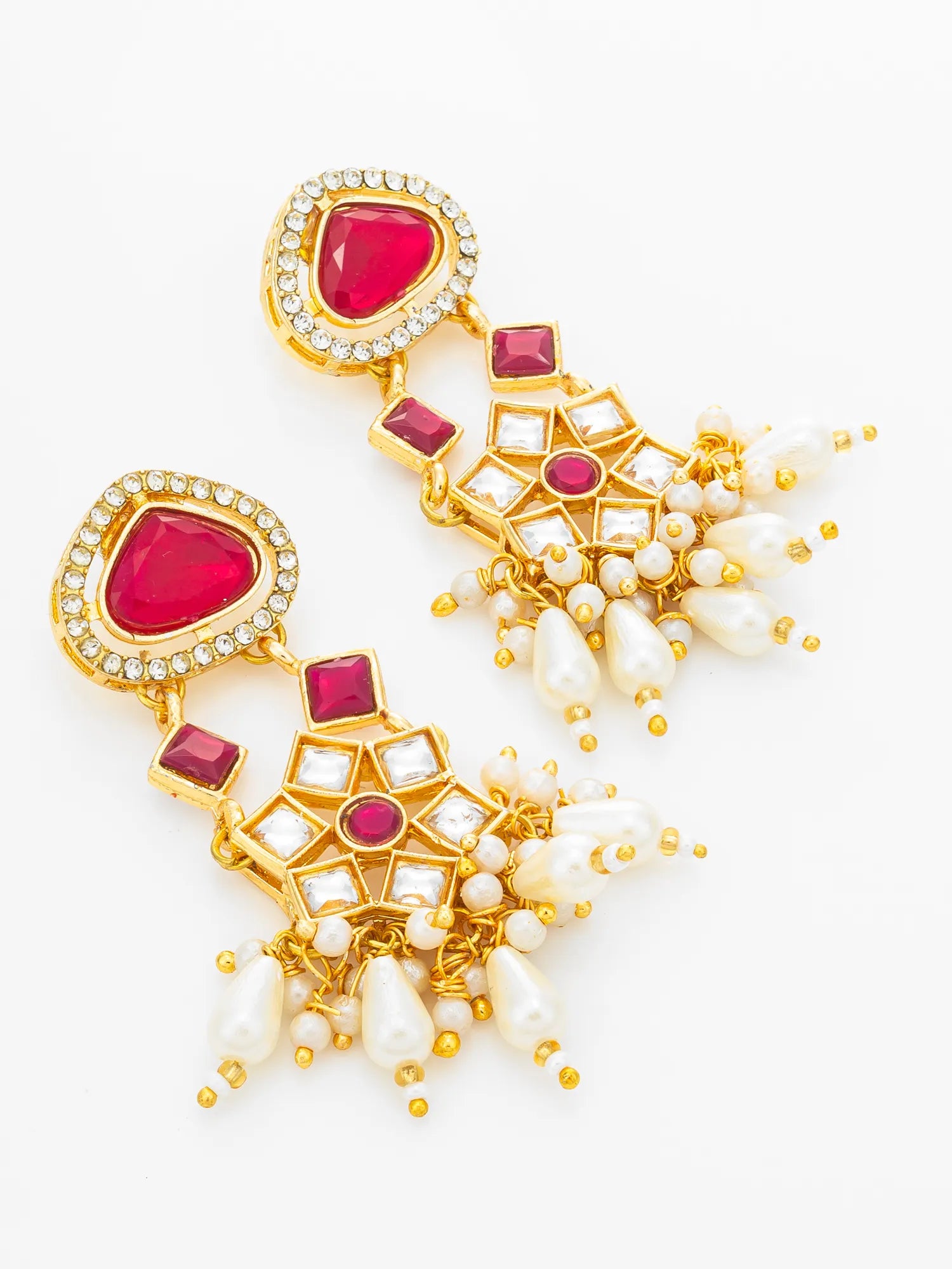 A pair of gold-plated statement dangle earrings featuring heart-shaped pink gemstones, clear crystal borders, and clusters of white faux pearls with small gold bead accents, set against a plain white background.