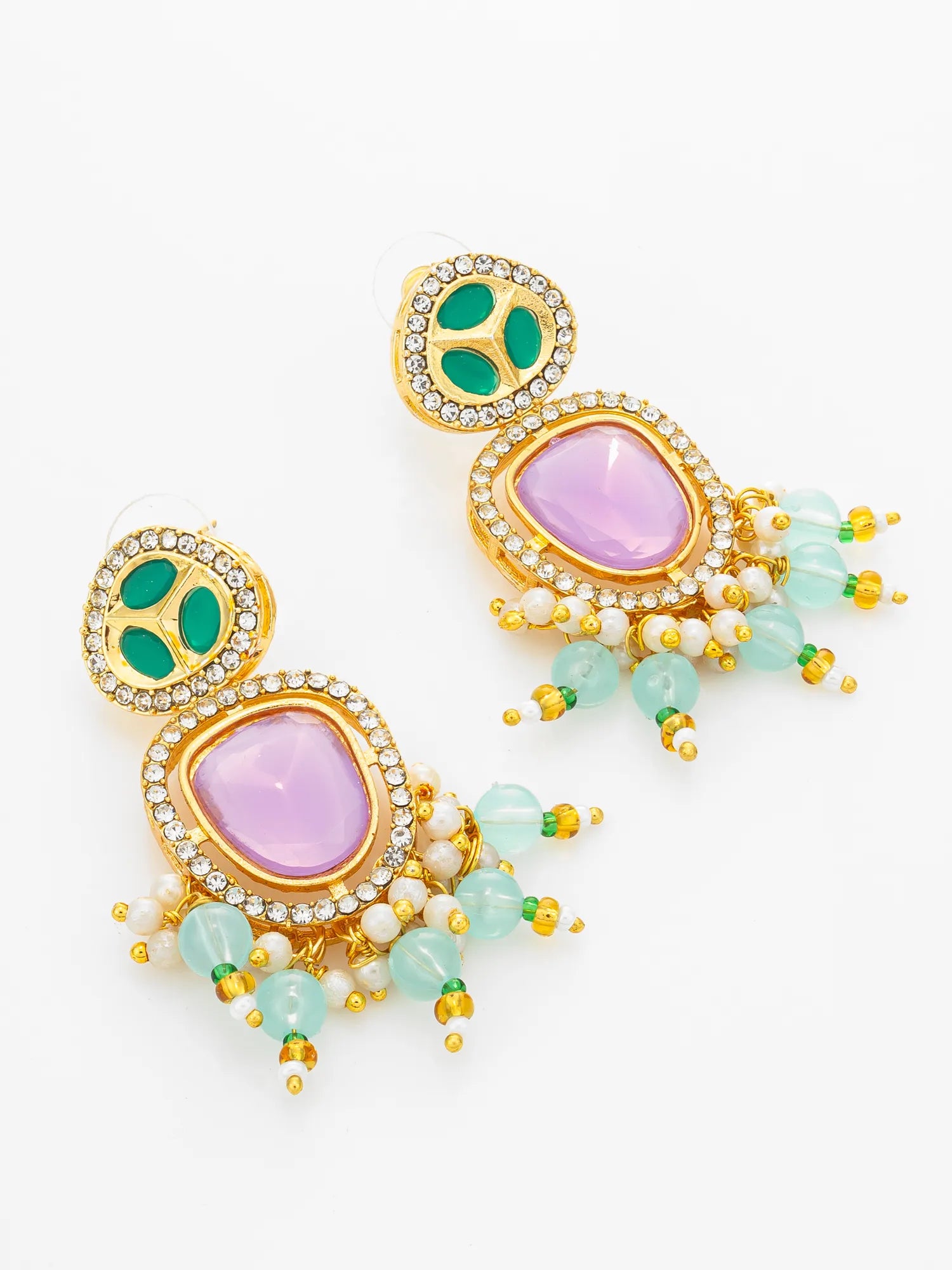A pair of gold-plated statement dangle earrings featuring large lavender purple oval stones, green oval stones, small white pearls, and light green bead drops on a white background.