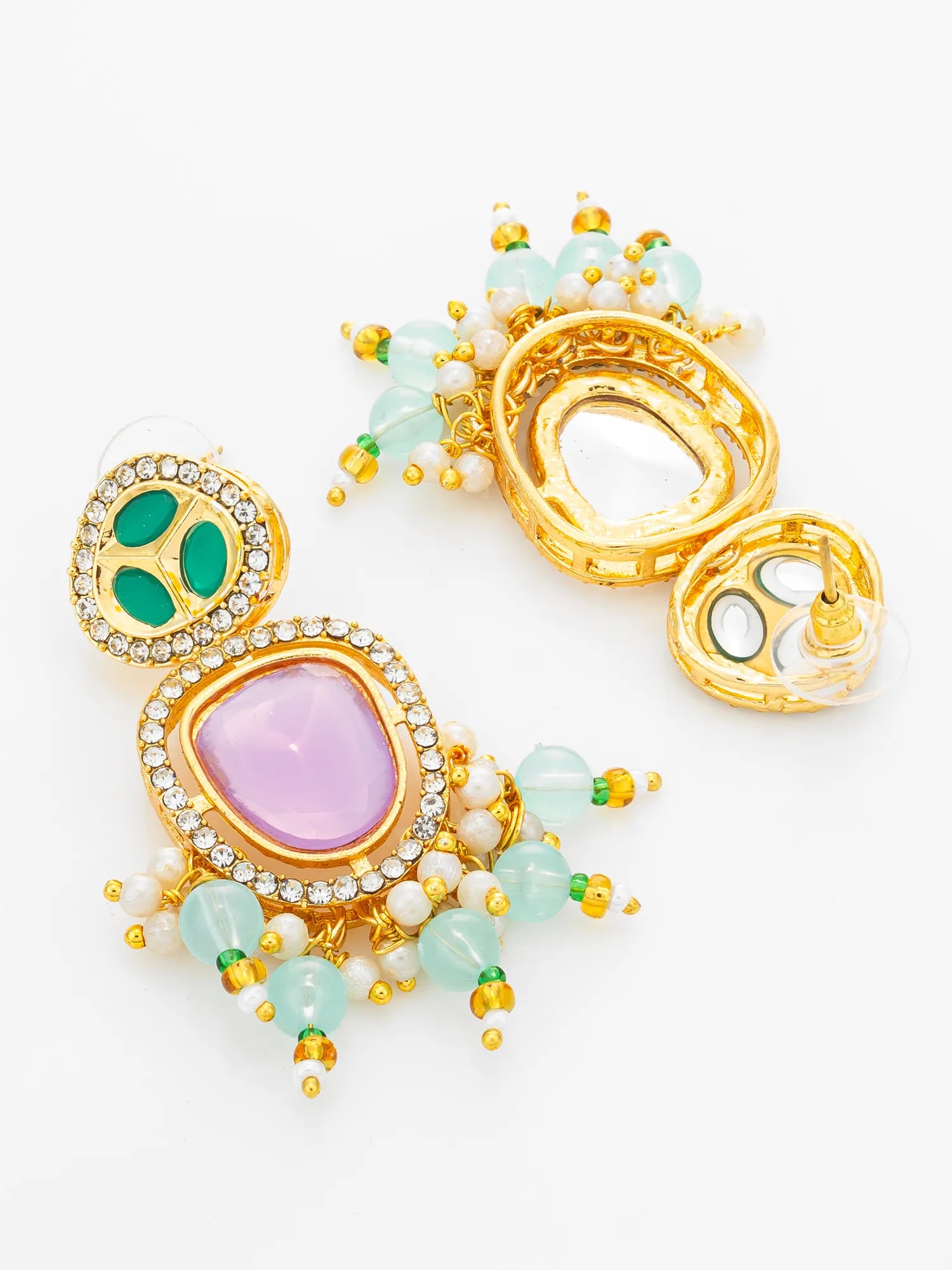 A pair of ornate gold-tone statement earrings with a large lavender oval stone, green oval stones, white pearls, and light blue beads on a white background.