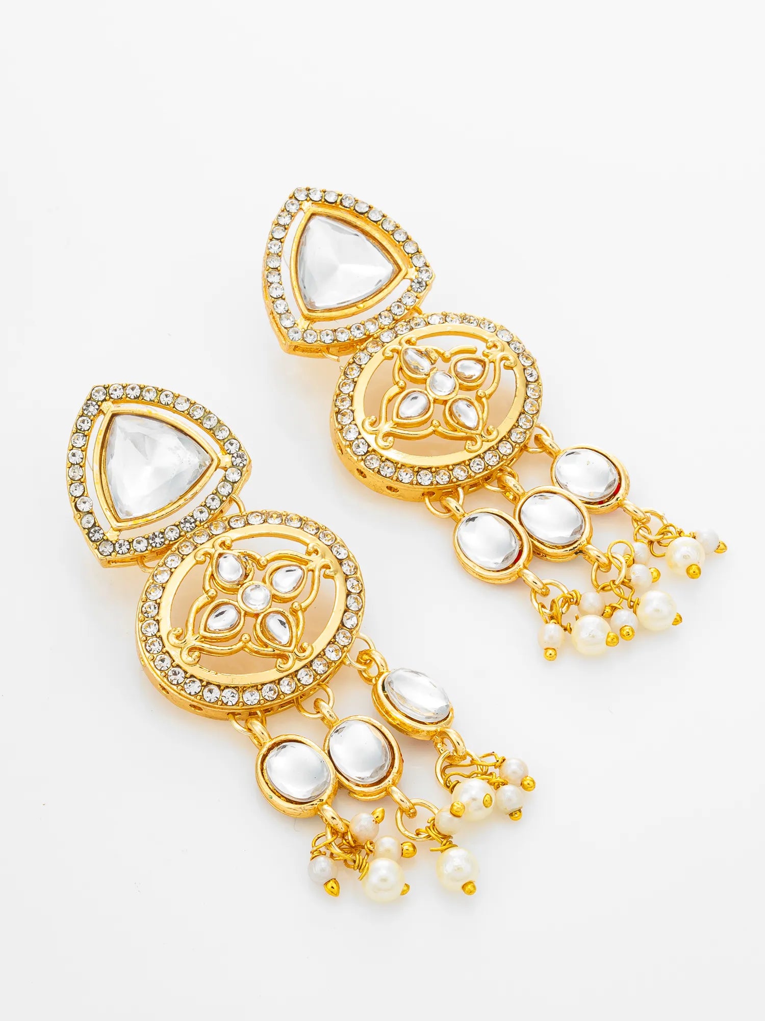 A pair of gold-toned statement earrings with clear rhinestone accents, white stone inlays, and dangling pearl-like bead chains, shown on a plain white background.