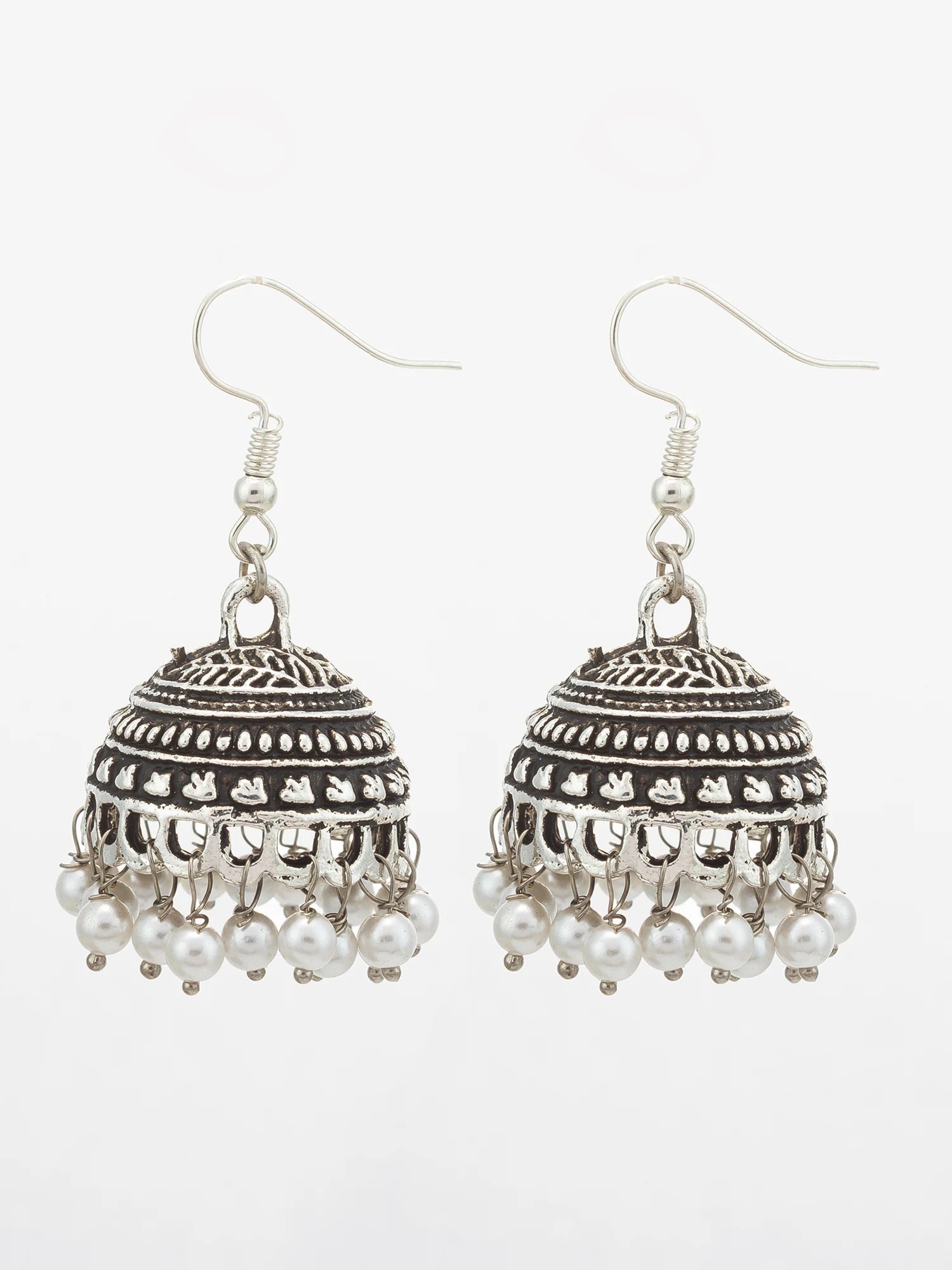 A pair of silver-toned traditional Indian jhumka earrings with intricate filigree detailing and dangling white pearl beads, shown against a plain white background.