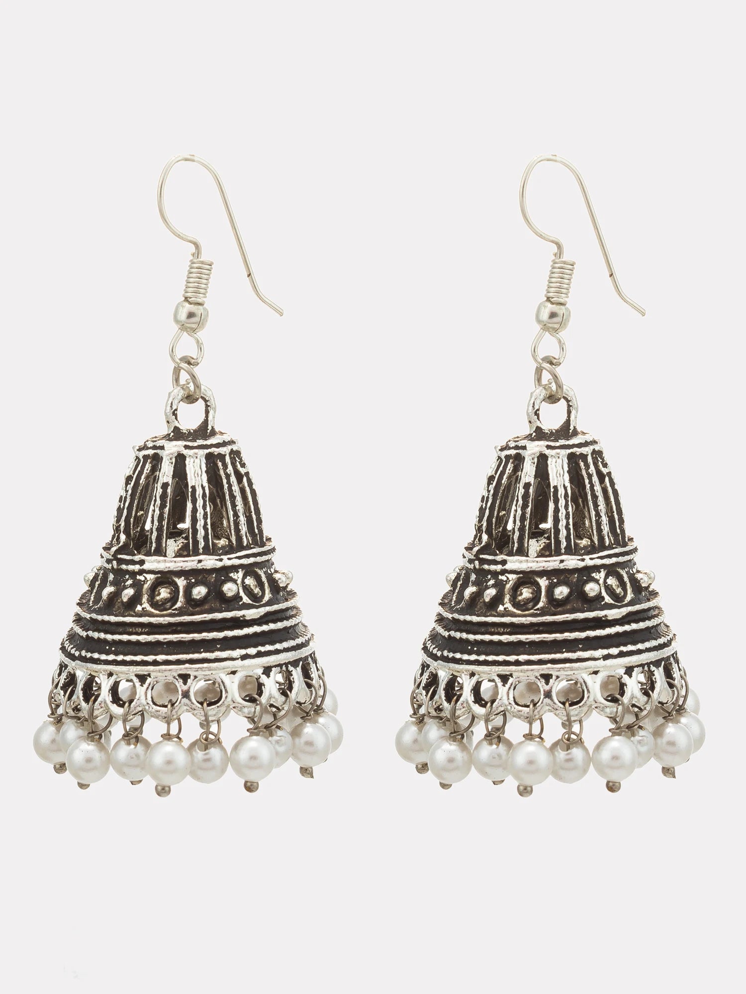 A pair of silver-toned Indian jhumka earrings with detailed filigree work and dangling pearl-like beads, shown against a light gray background.
