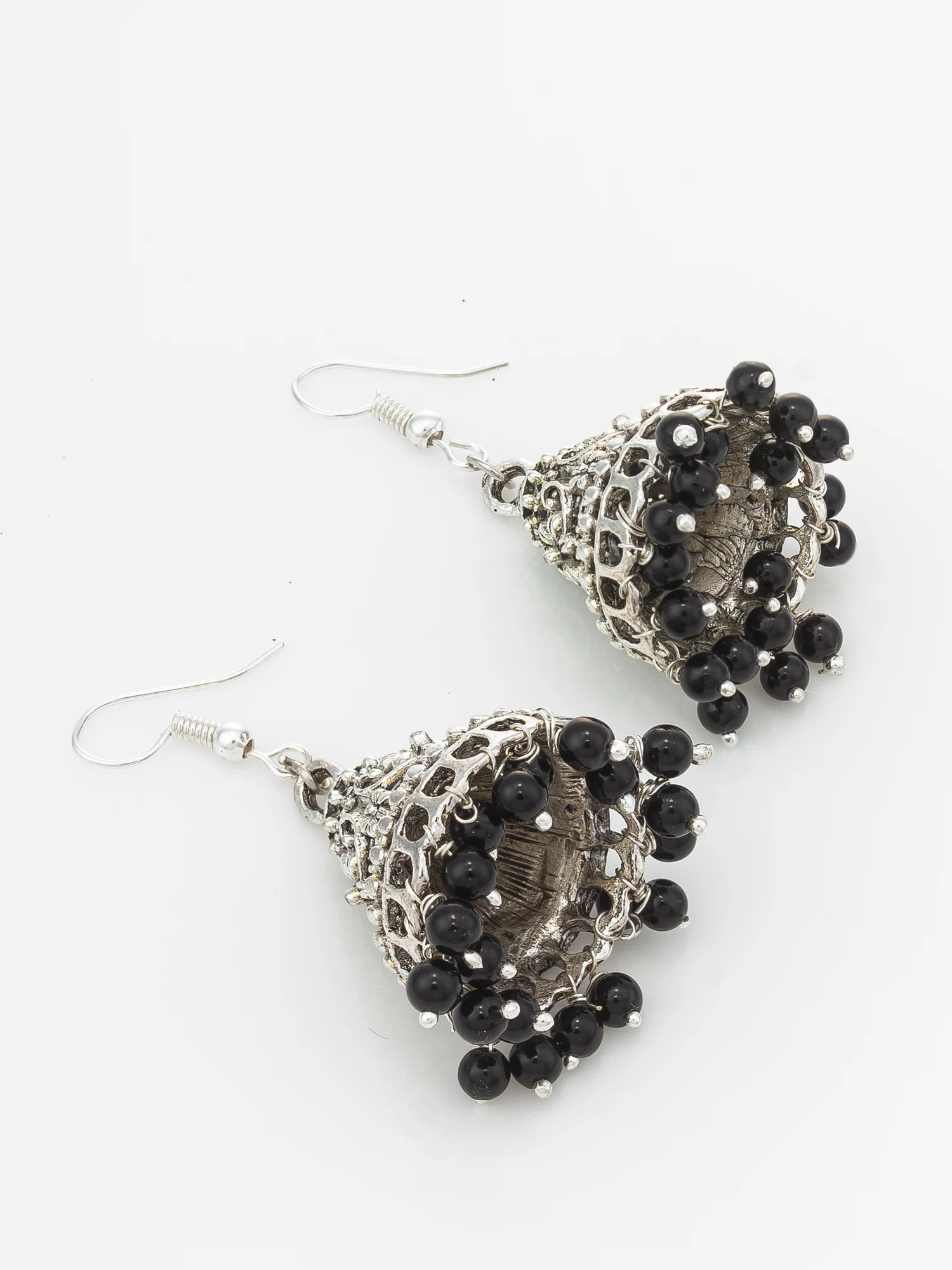 A pair of silver-toned filigree dangle earrings with clusters of small black beads, shown on a plain white background.