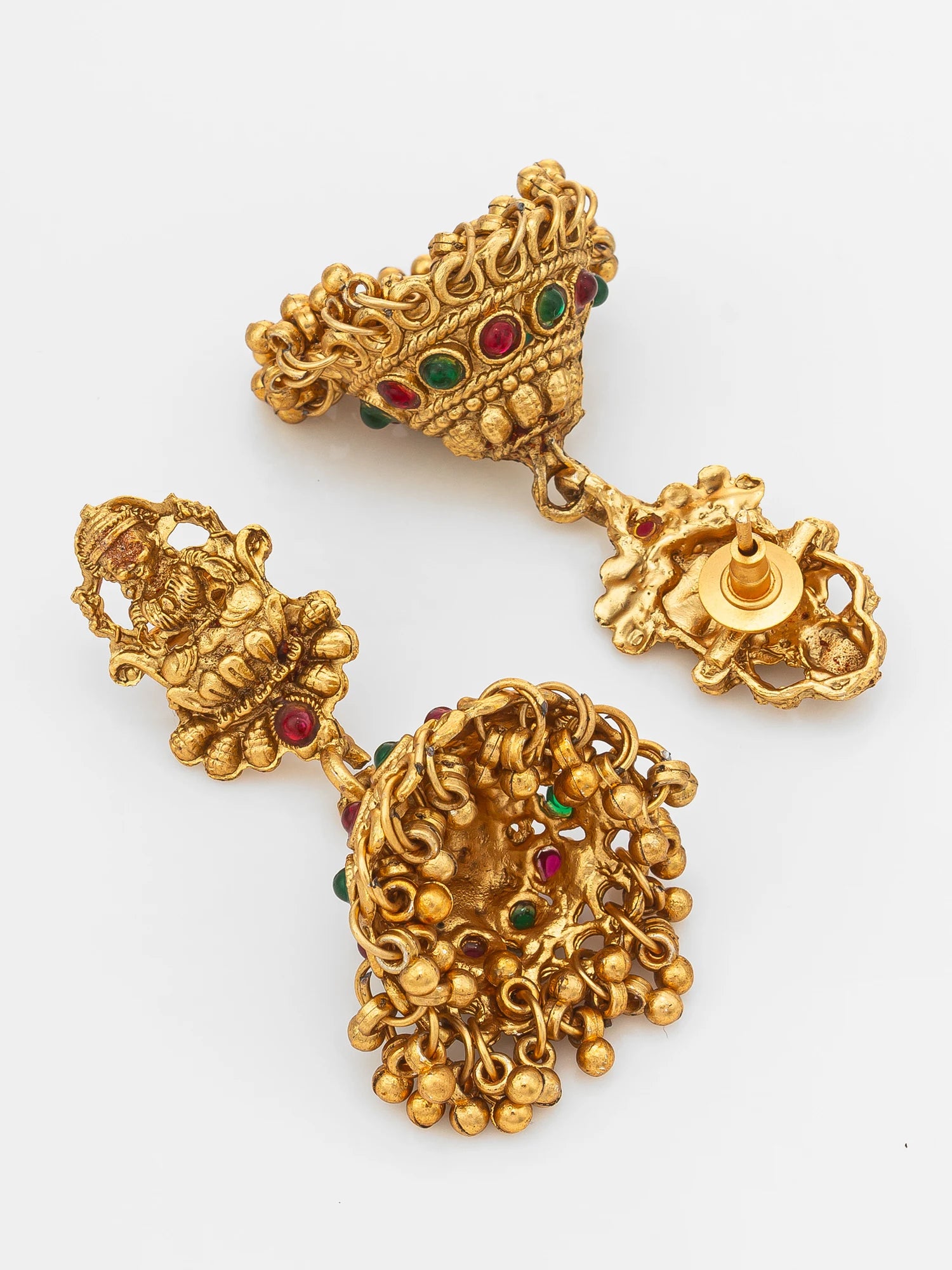 A pair of ornate gold-toned traditional earrings with red and green stone accents, displayed on a clean white background.