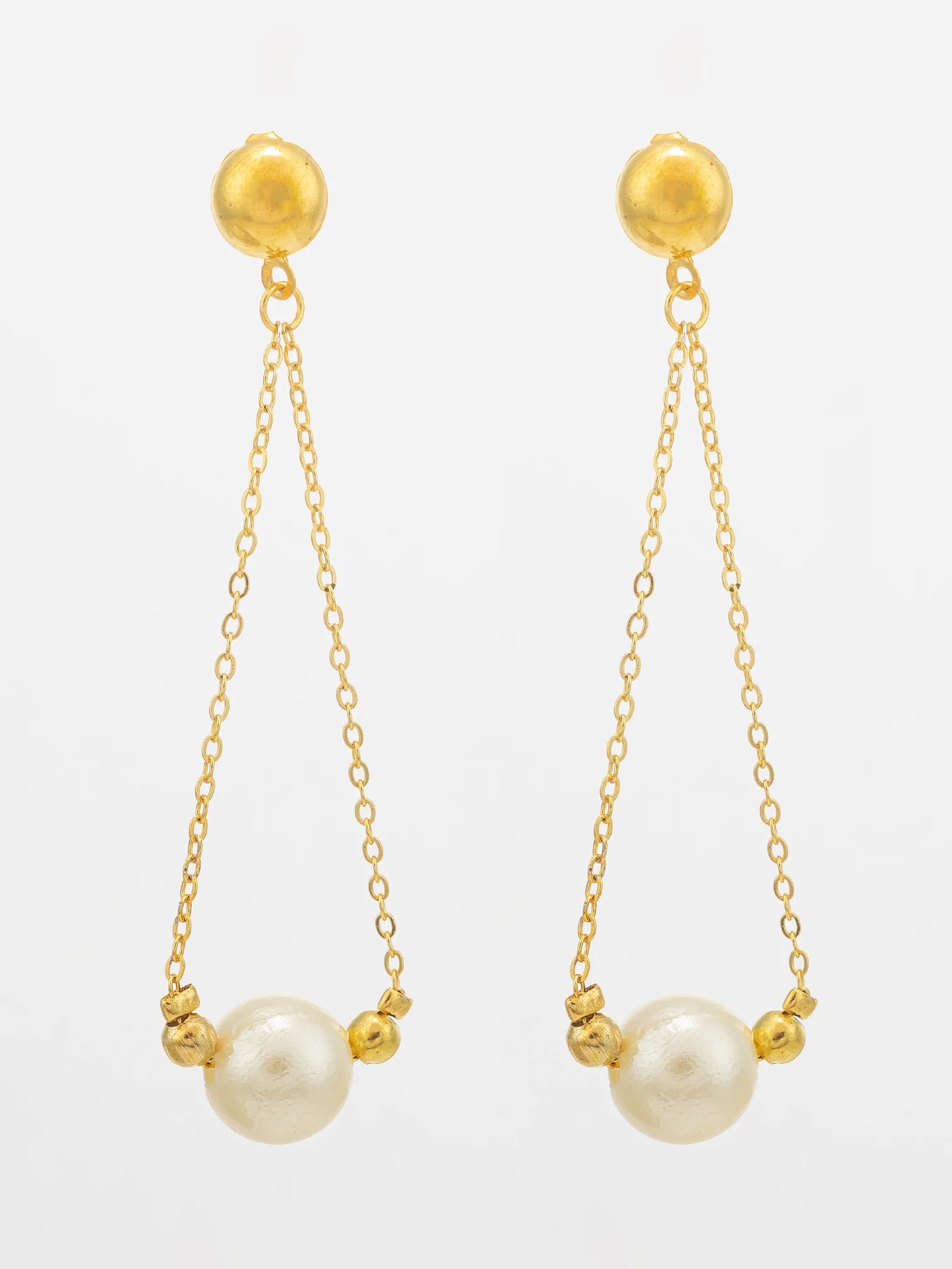 A pair of gold dangle earrings with spherical gold posts, delicate chains, and large white pearl beads at the bottom, shown against a plain white background.