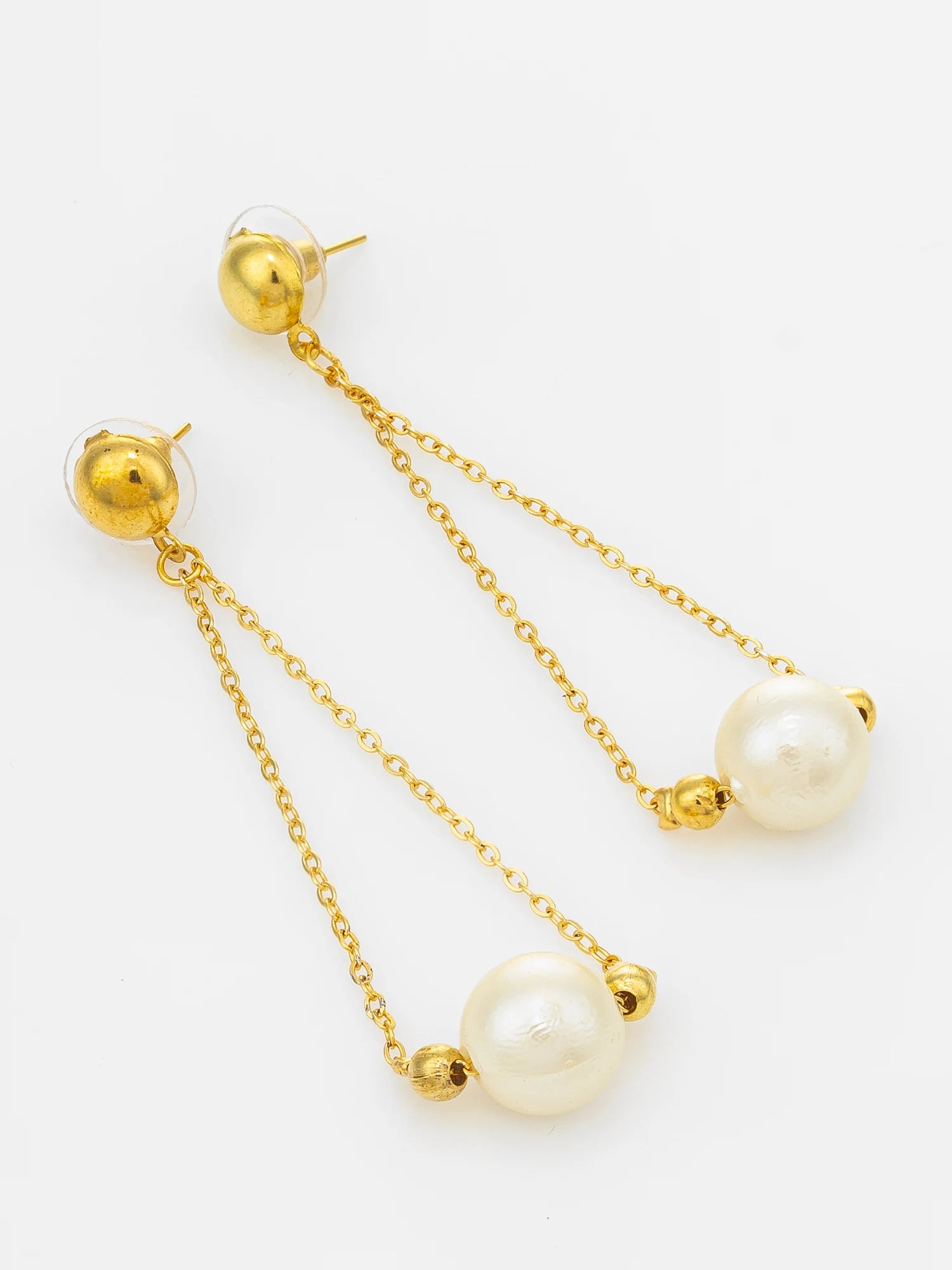 A pair of gold-tone dangle earrings with large white pearl beads and small gold spacer beads, shown on a clean white background.