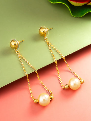 Gold drop earrings with a large pearl and small gold beads, displayed on a split green and pink background.