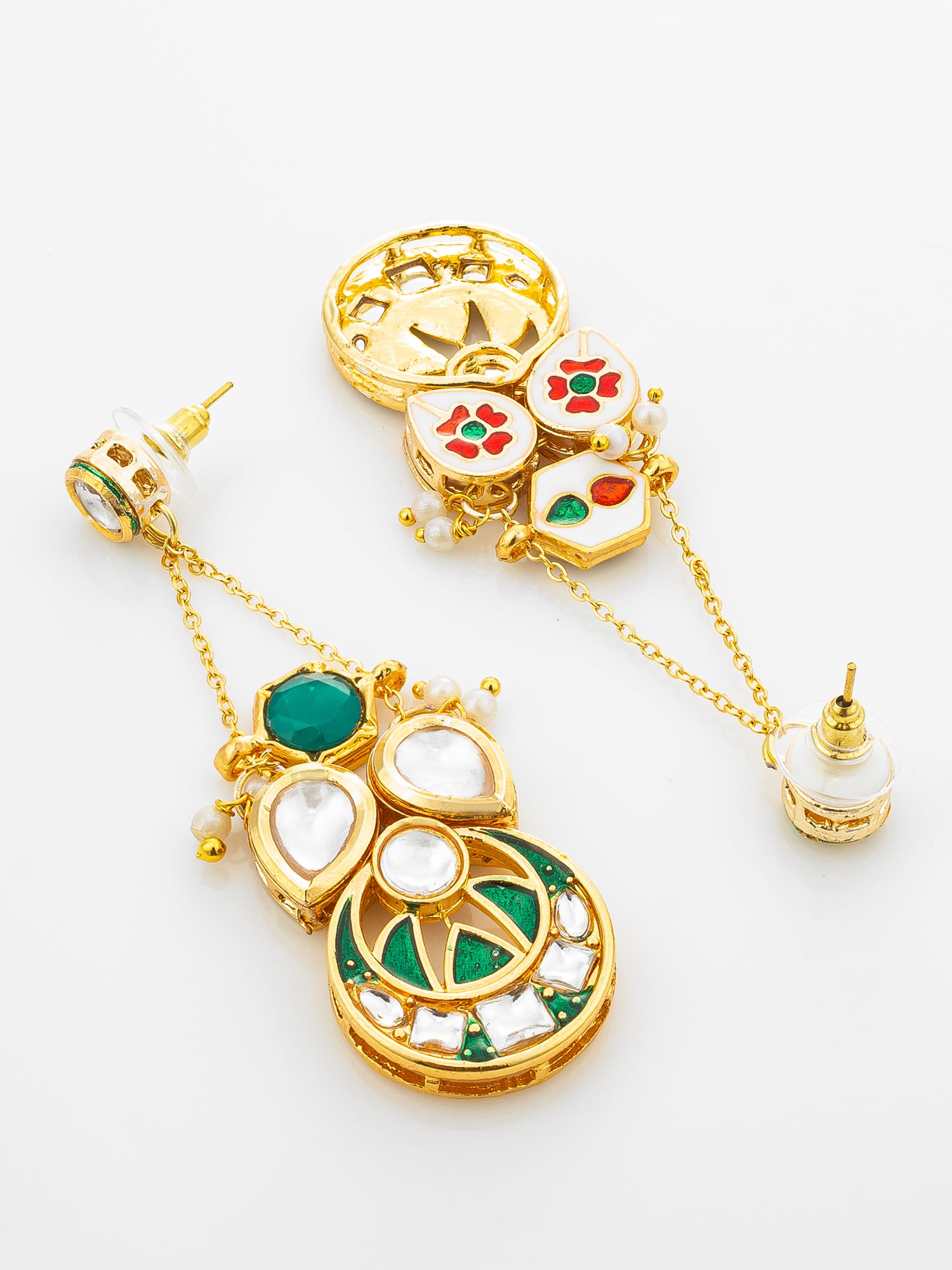 A pair of ornate gold-plated statement earrings with intricate white, green, and red enamel details, set against a clean white background.
