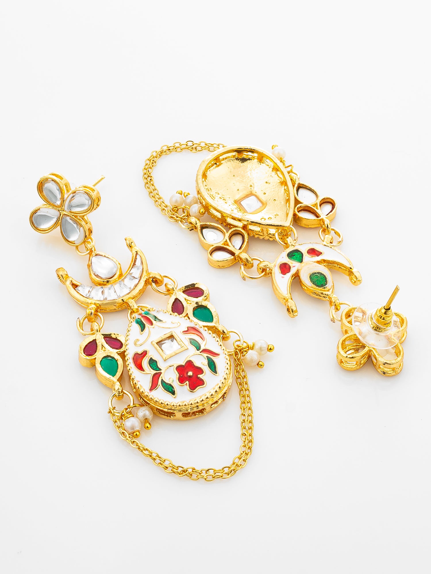 A pair of gold-plated Indian Kundan earrings with intricate floral and paisley designs, featuring white stones, red and green enamel accents, and small pearl beads on a clean white background.