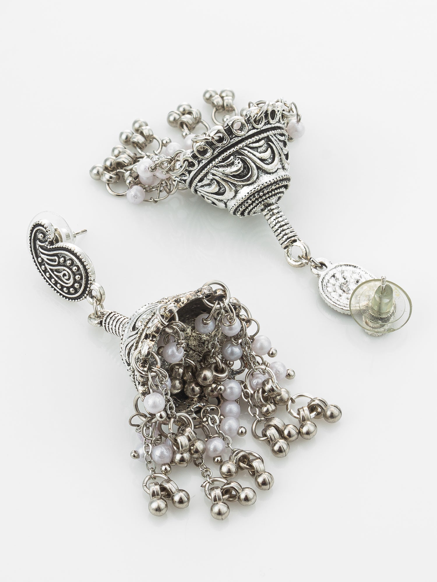 A pair of ornate silver-toned tassel earrings with paisley details and dangling bead chains, displayed on a clean white background.