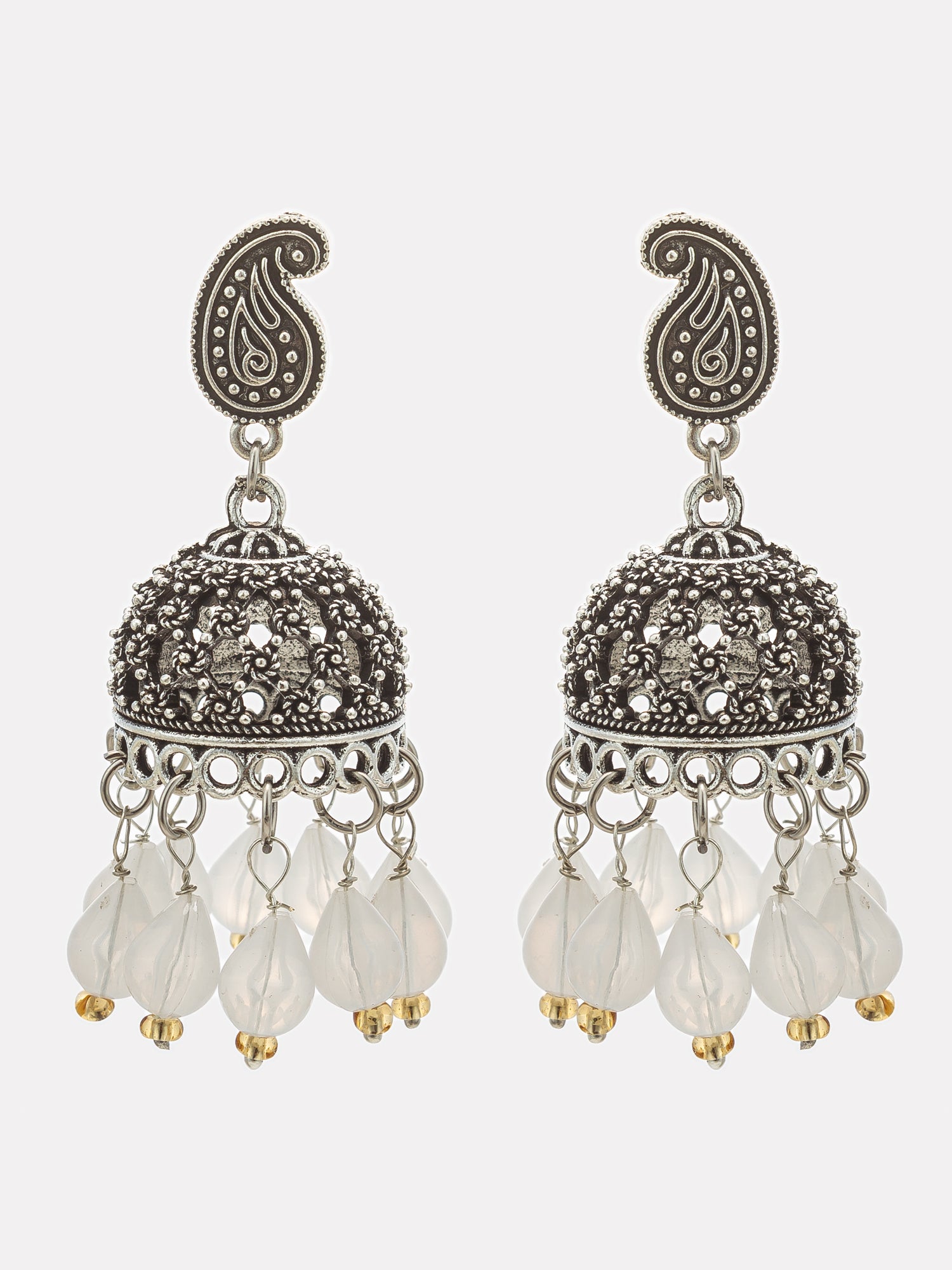 A pair of traditional Indian jhumka earrings with oxidized silver paisley studs, ornate filigree dome tops, and hanging translucent white glass beads with small gold accents, shown against a light gray background.