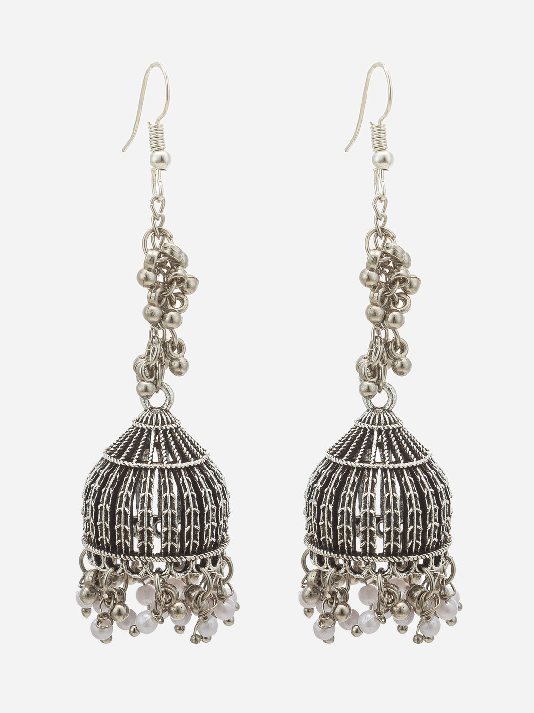 A pair of silver-toned filigree dangle earrings with small white bead accents, displayed against a dark black background.