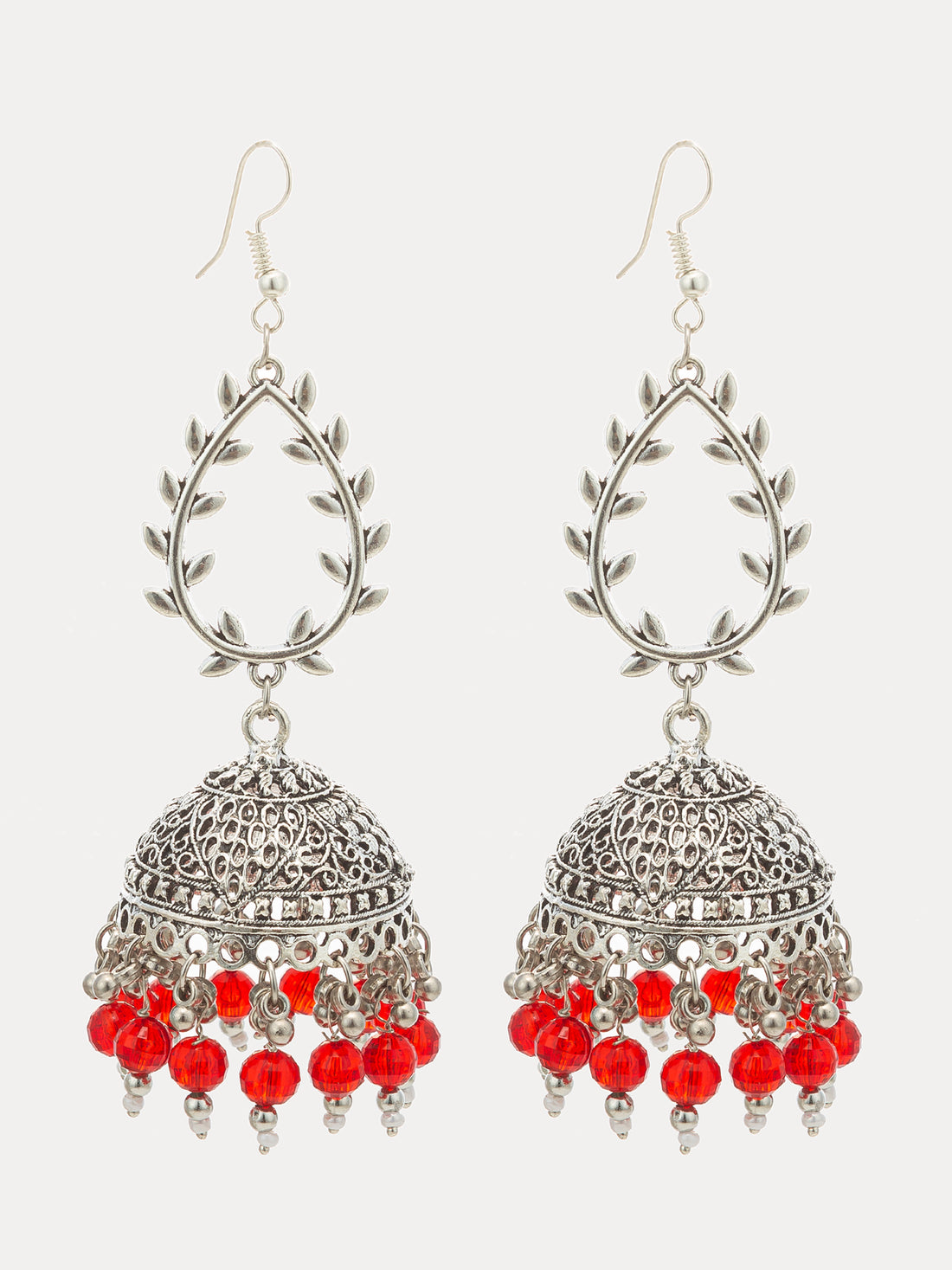 A pair of silver-toned Indian jhumka earrings with red bead accents, displayed against a dark background.