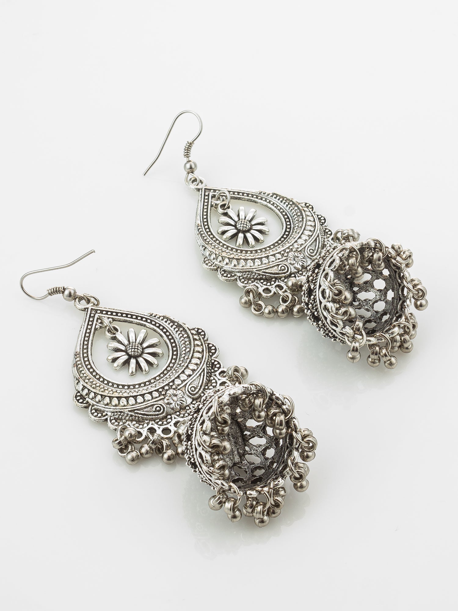 A pair of silver-toned traditional Indian jhumka earrings with intricate filigree work and dangling bead clusters, displayed on a clean white background.