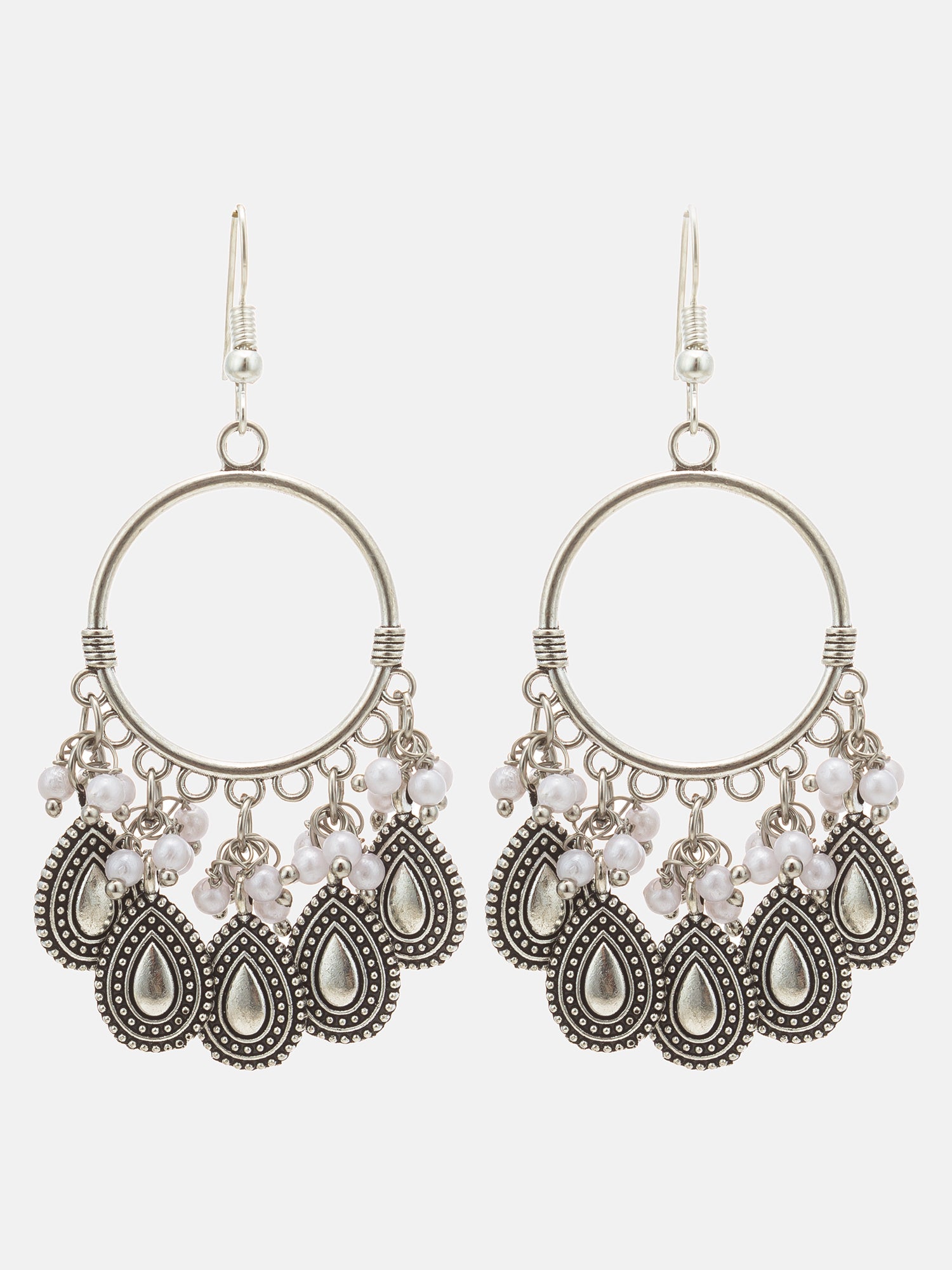 A pair of bohemian-style silver-toned dangle earrings with circular hoops, small pearl-like beads, and teardrop-shaped metal charms on a light gray background.