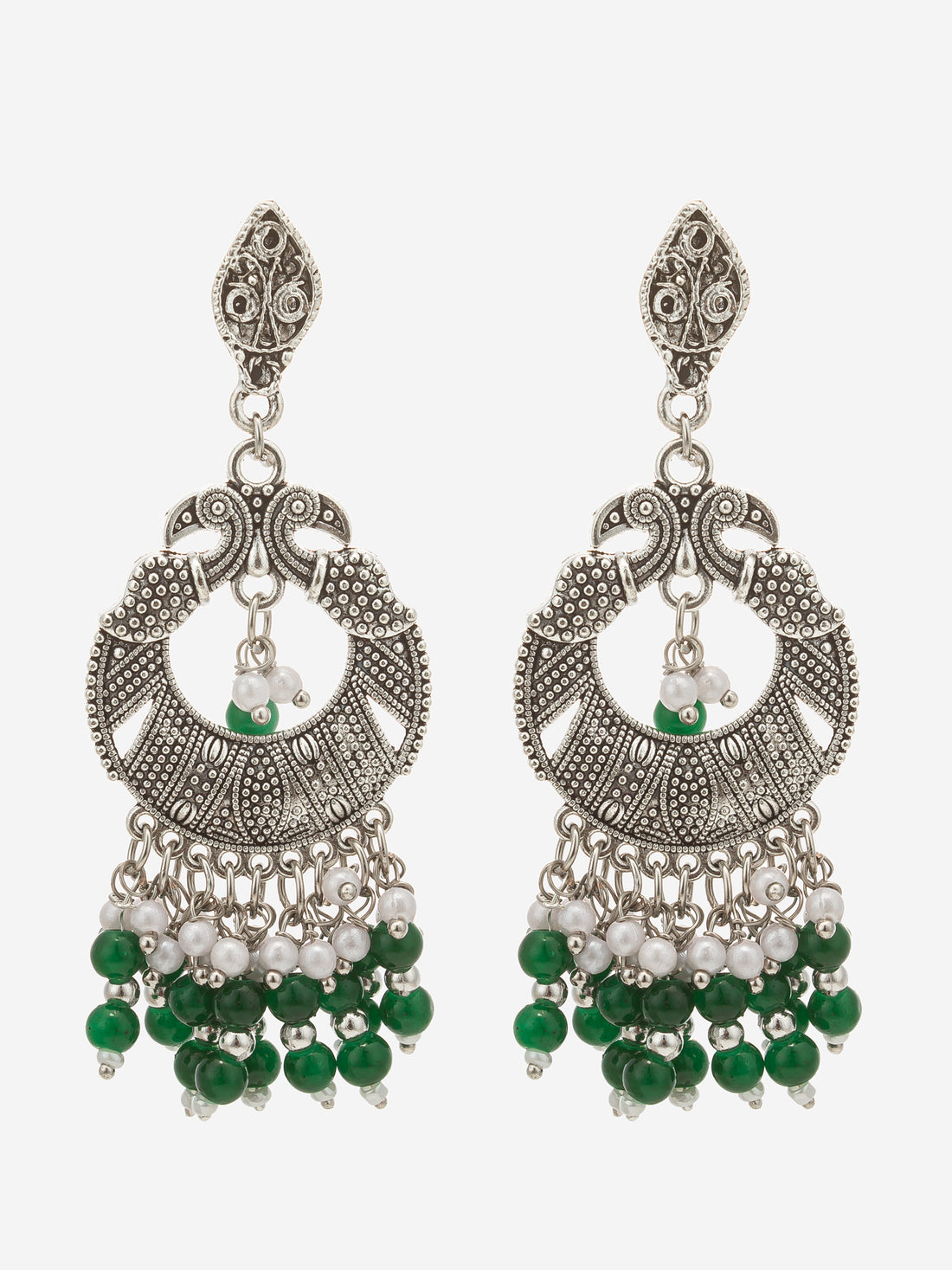 A pair of silver-toned traditional Indian chandbali earrings decorated with green and white beads, displayed on a dark reflective surface.