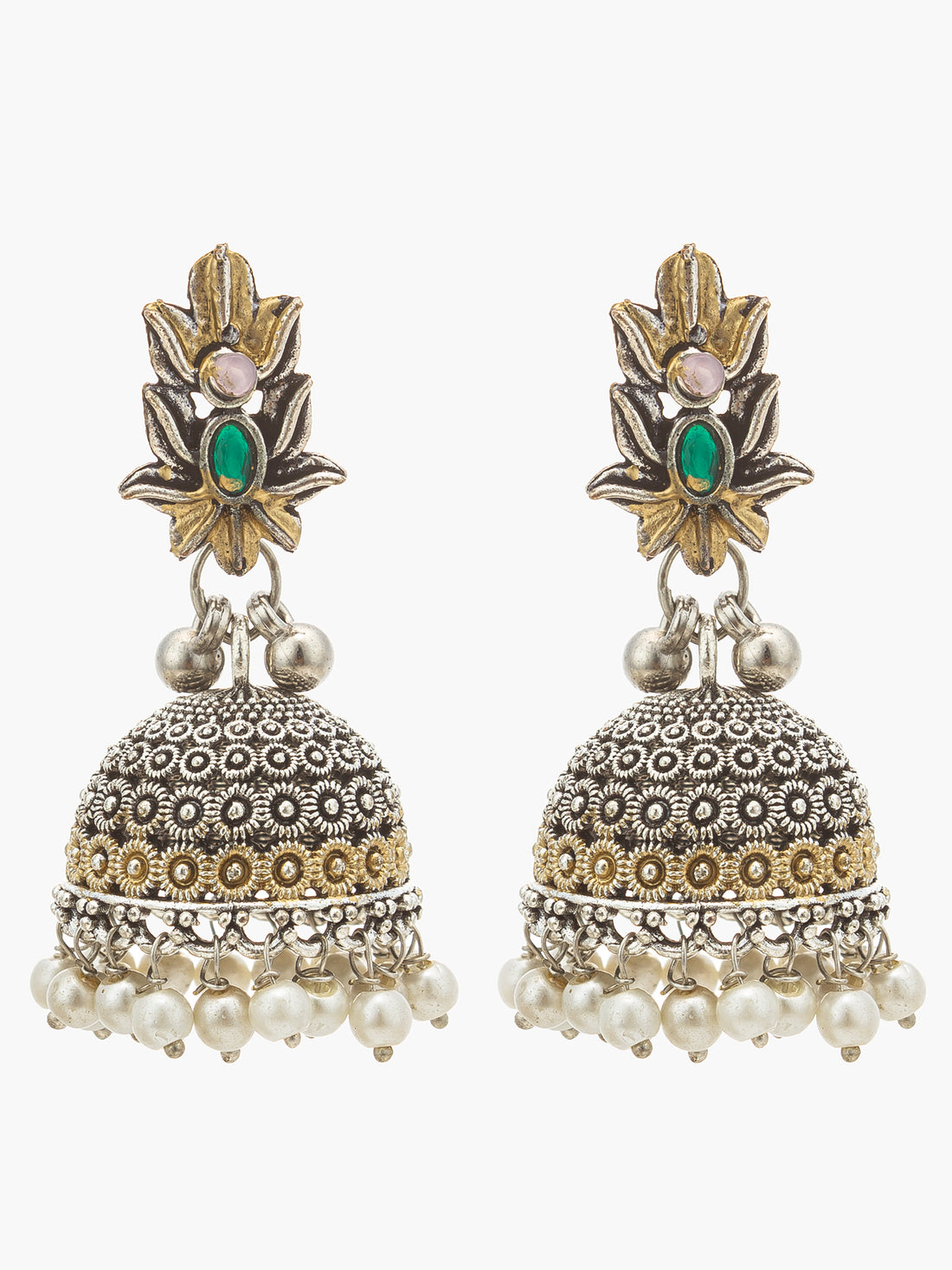 A pair of ornate Indian jhumka earrings with silver filigree bells, gold accents, and small pearl drops, displayed on a black ceramic dish against a dark background.