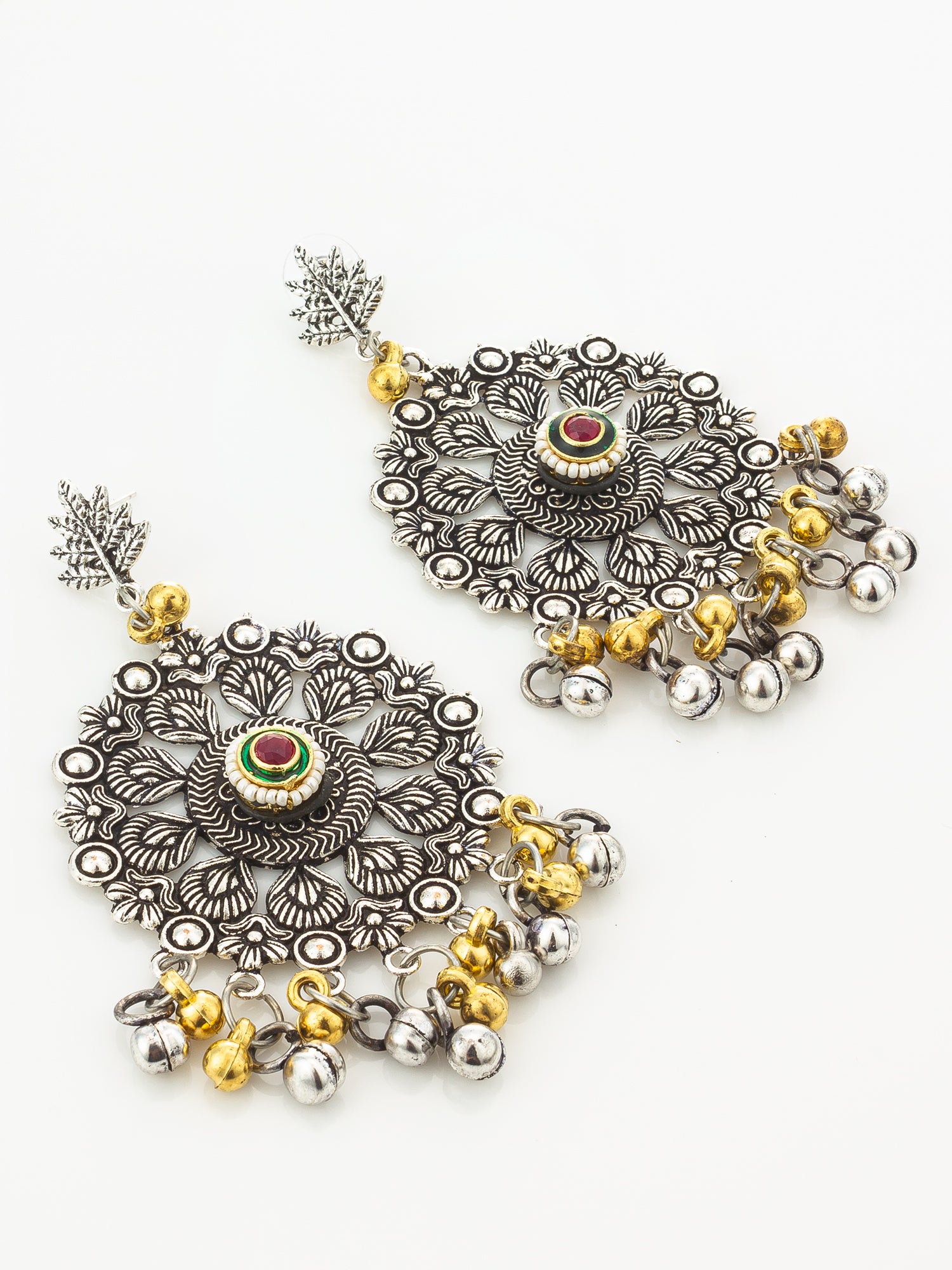 A pair of ornate silver-toned dangle earrings with intricate filigree detailing, small gold-toned bead accents, and central red and green stone embellishments, displayed on a clean white background.