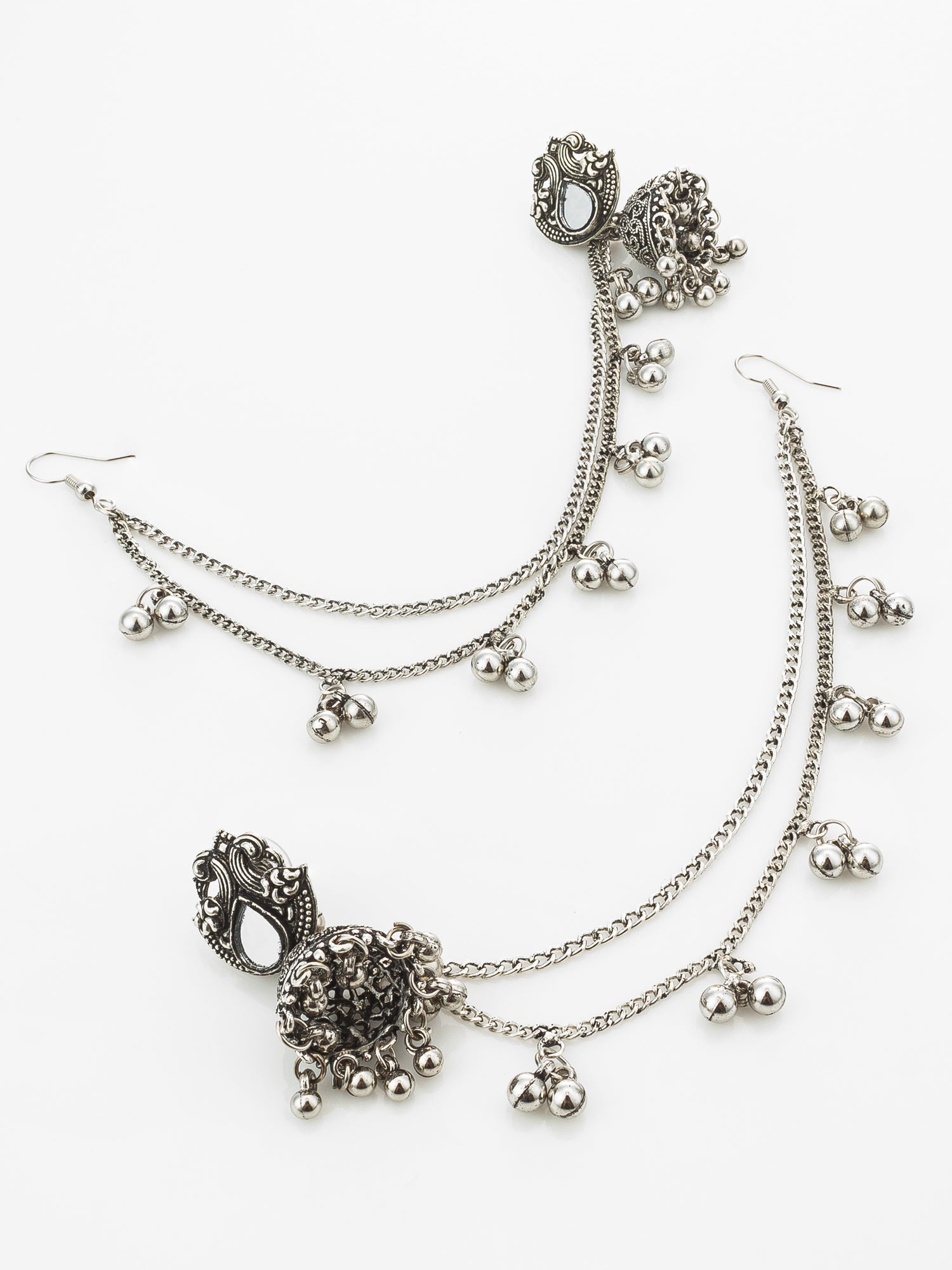 A pair of silver-toned double-layered chain anklets with ornate filigree details and dangling bell charms, displayed on a clean white background.