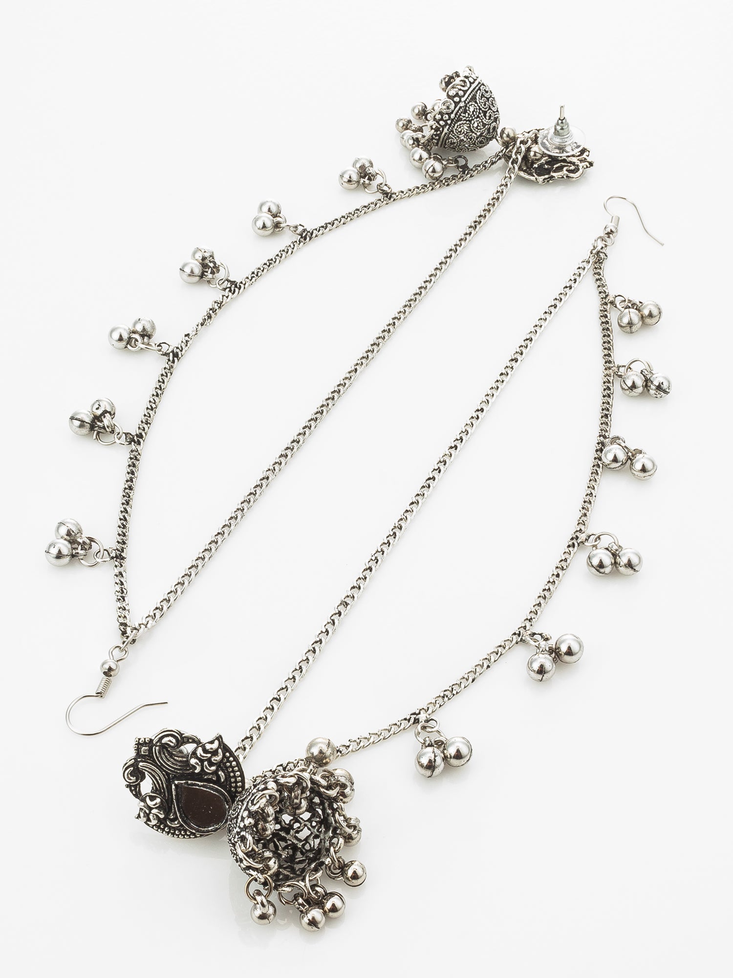 A silver-toned double-layered chain anklet with ornate filigree pendants, dangling bell charms, and hook backings, displayed on a clean white background.