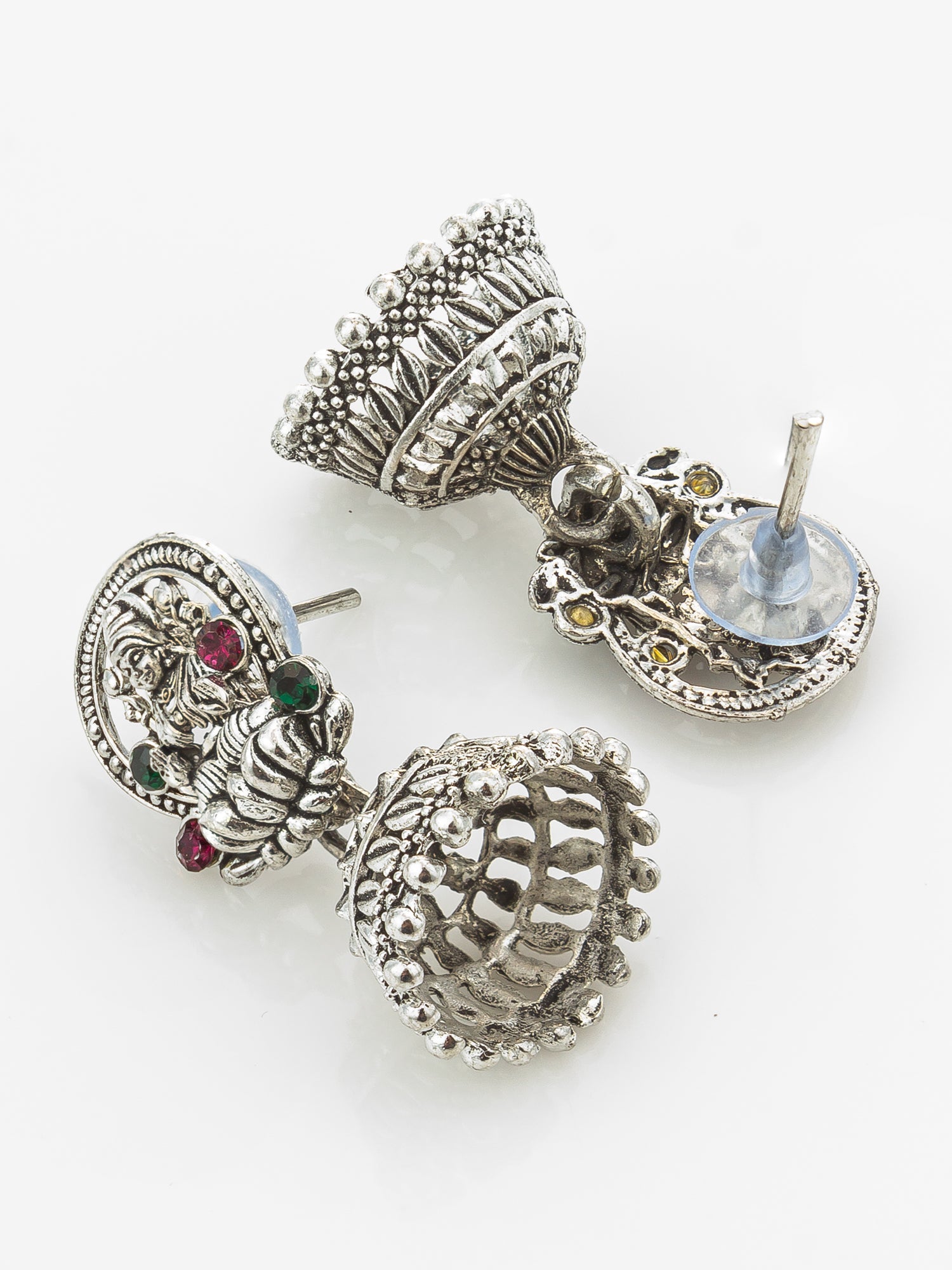 A pair of ornate silver-toned traditional earrings with intricate filigree, beadwork, and small colored gemstone accents, displayed on a clean white background.