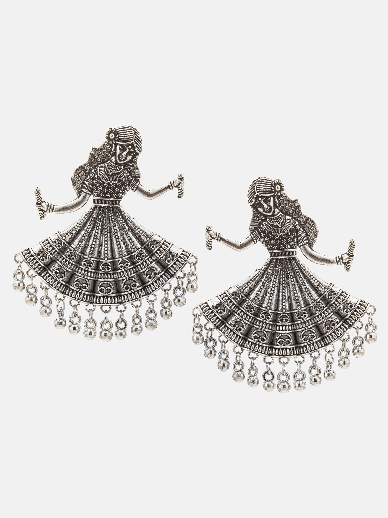 A pair of silver-toned jhumka earrings featuring a detailed dancing woman motif with dangling bell chains, shown on a light gray background.