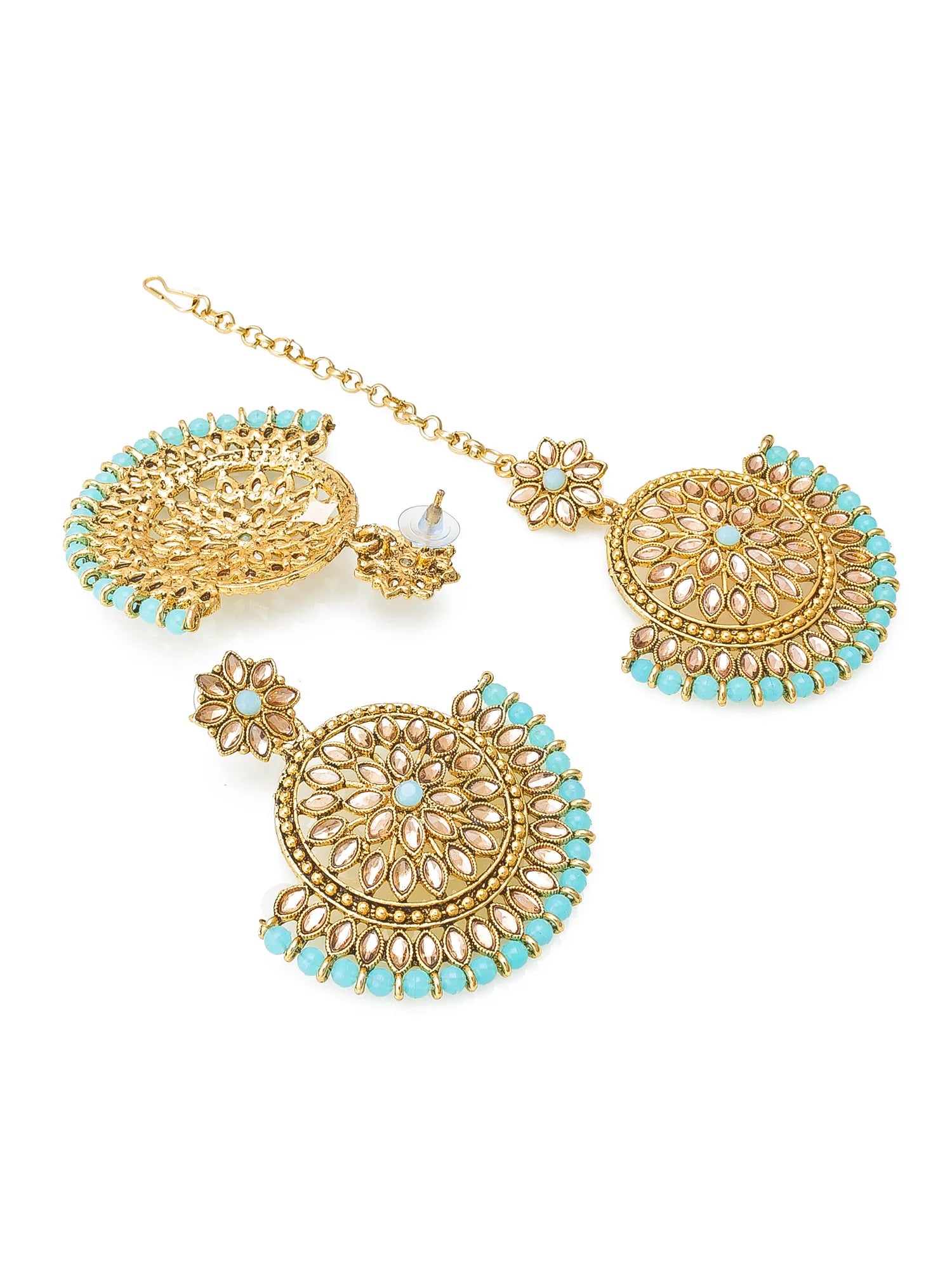 Gold and turquoise jewelry set on a white background