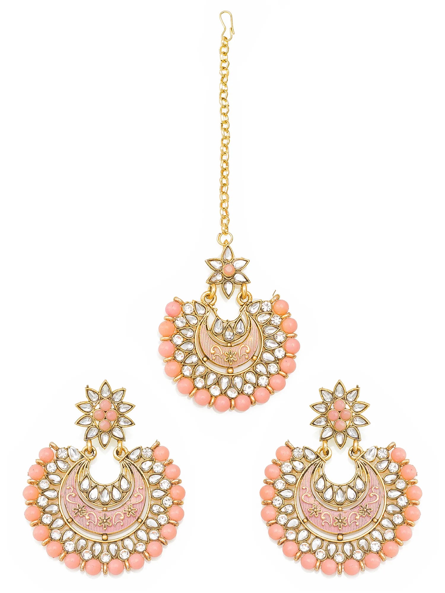 Gold-plated Indian traditional jewelry set featuring a matching manjika pendant and two matching dangle earrings, decorated with pink enamel, peach beads, and clear stones on a white background.