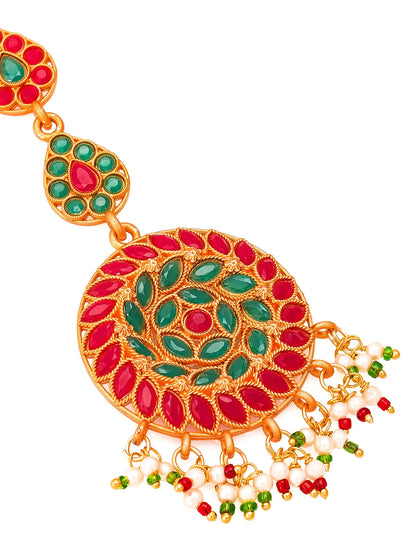 Ornate gold earring with red and green gemstones on a white background