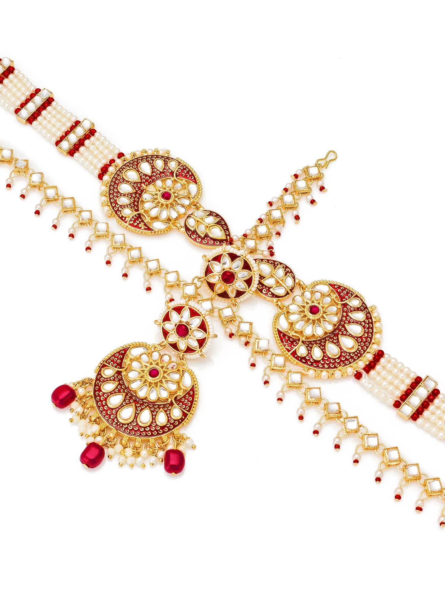 Gold and red jewelry set on a white background