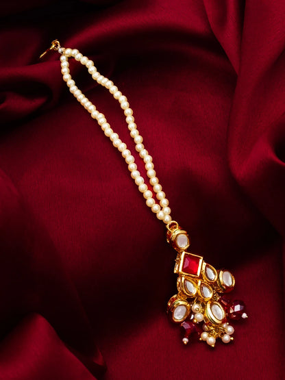 Pearl necklace with a decorative pendant on a red fabric background