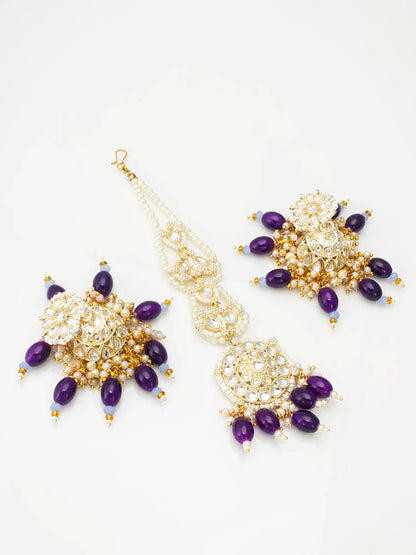 Pair of gold and purple beaded earrings on a white background
